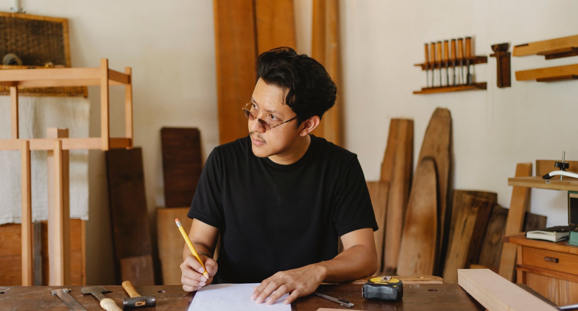 A small business owner planning their brand strategy at a worktable