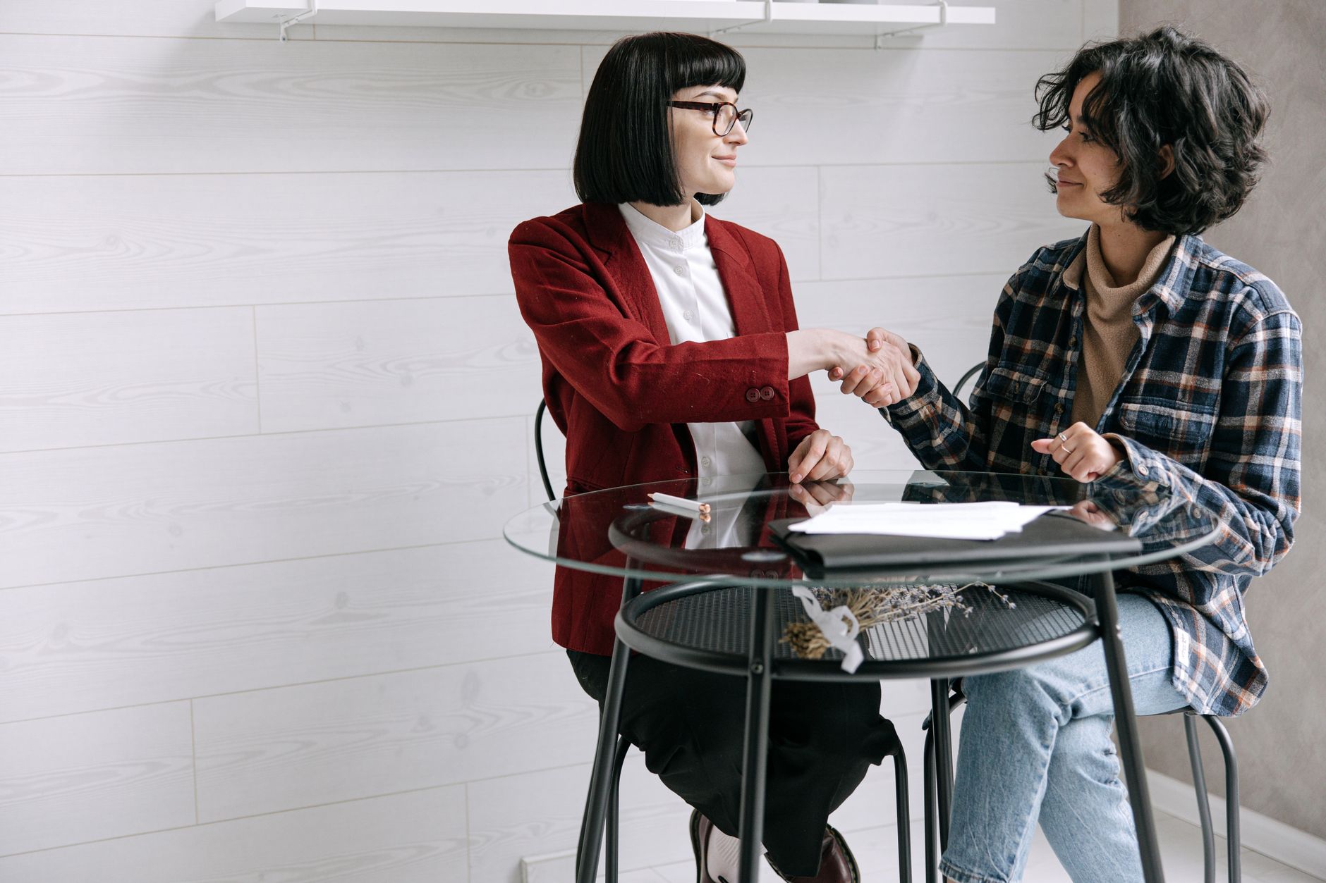 An accountant greeting a long-standing client at their office