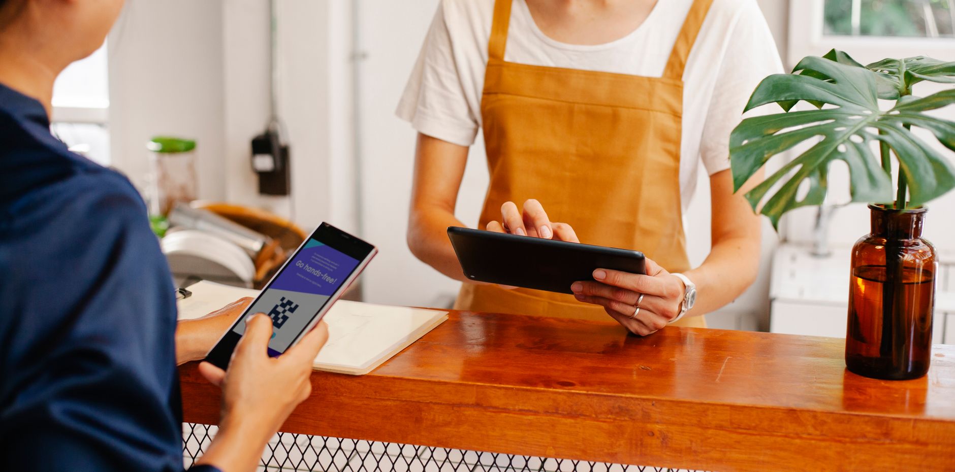 Close interaction of hands exchanging cash in a café setting. Business transaction detail.