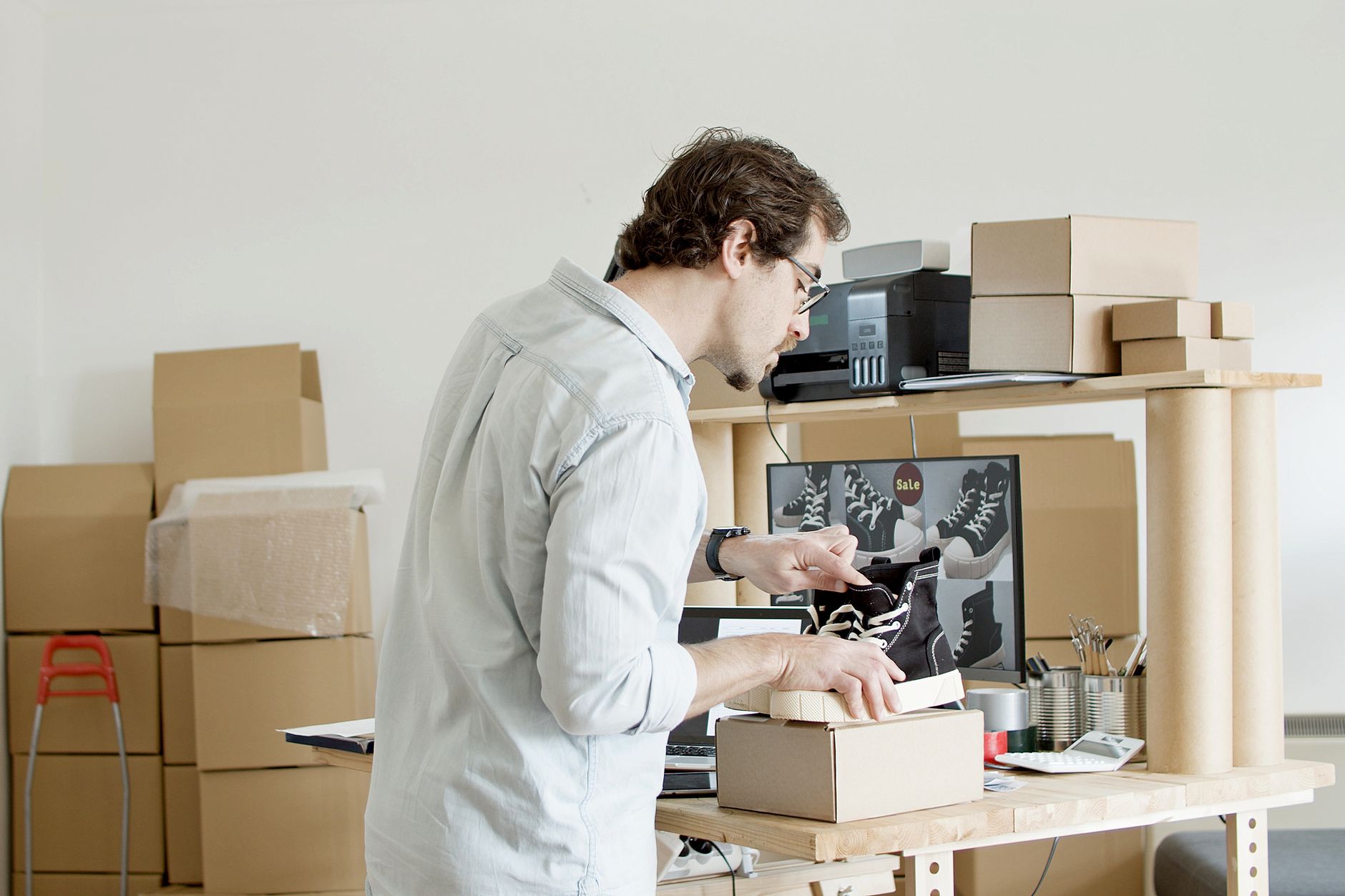 A small business owner packing an online order ready for dispatch