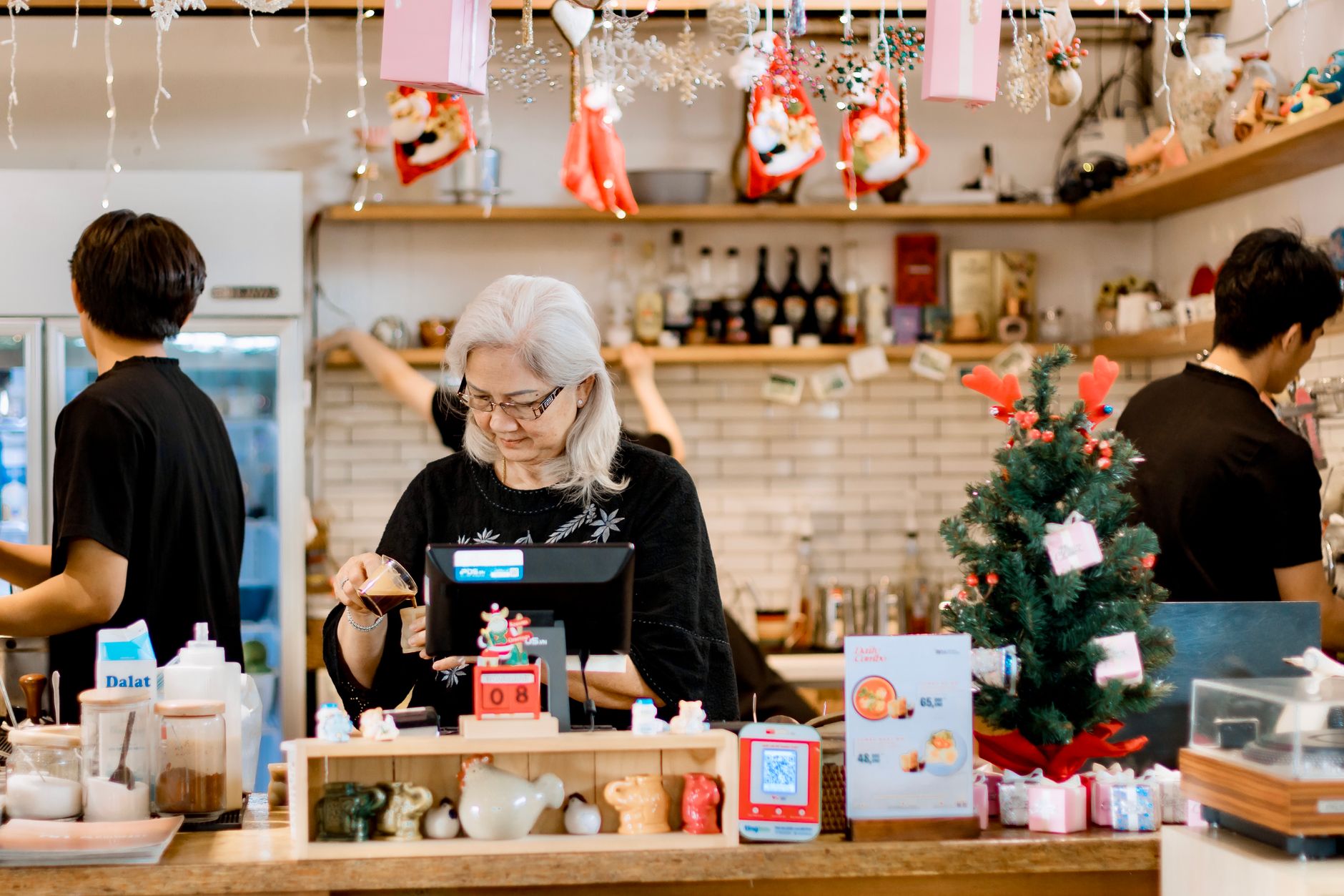 A small business owner reviewing their marketing numbers in a notebook