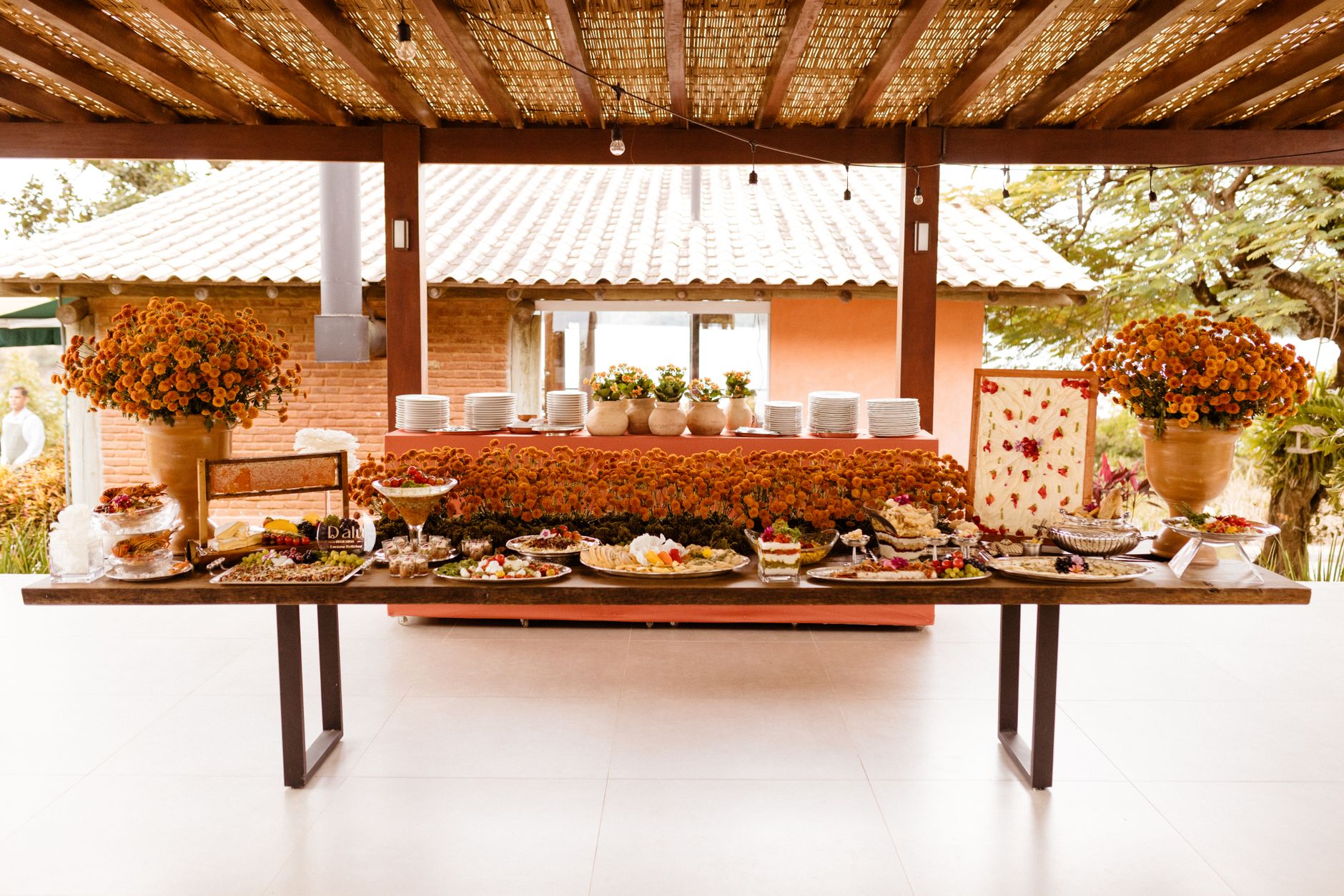 A caterer arranging plated dishes before a wedding reception