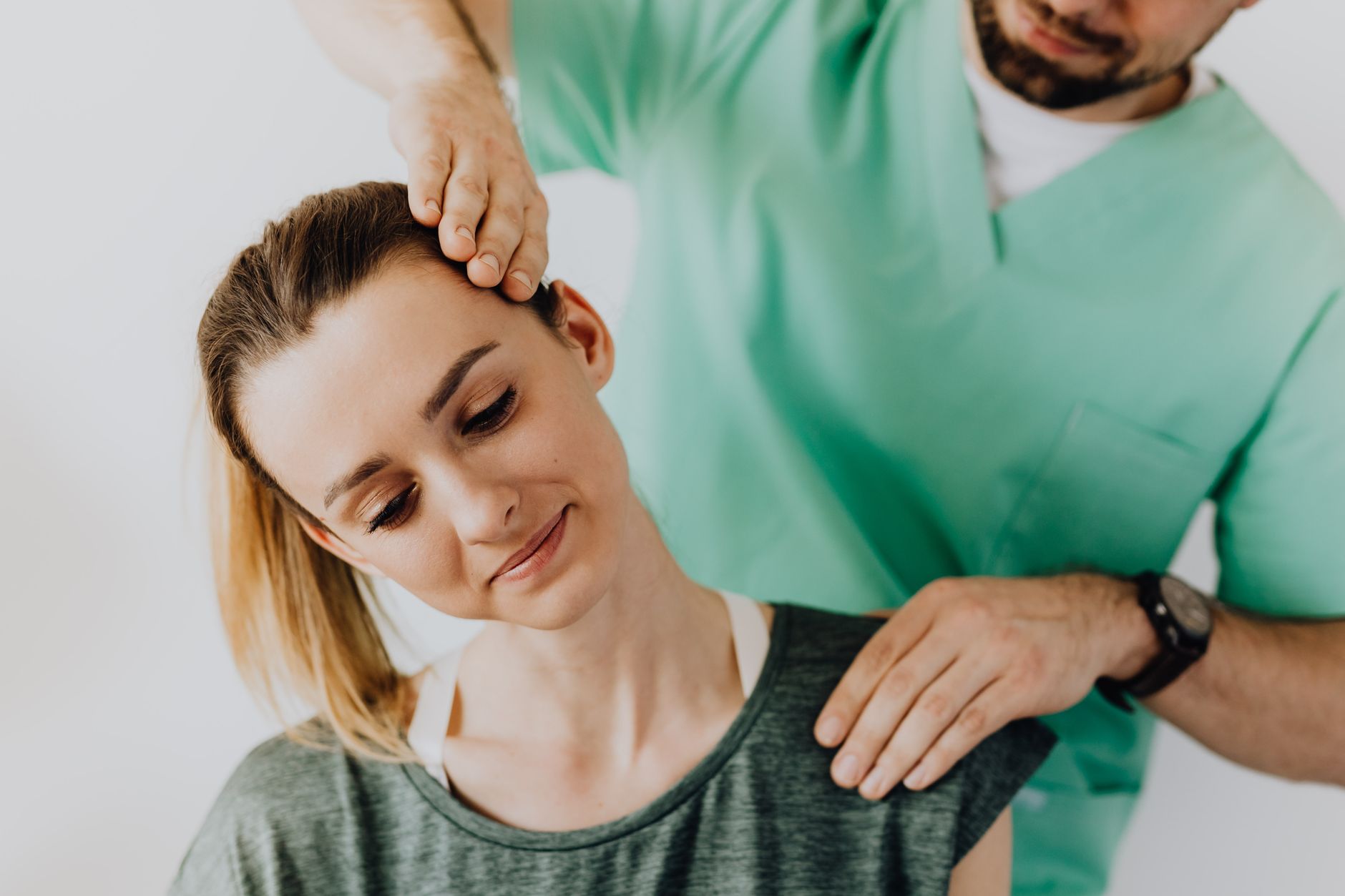 A chiropractor treating a patient in a small, welcoming clinic