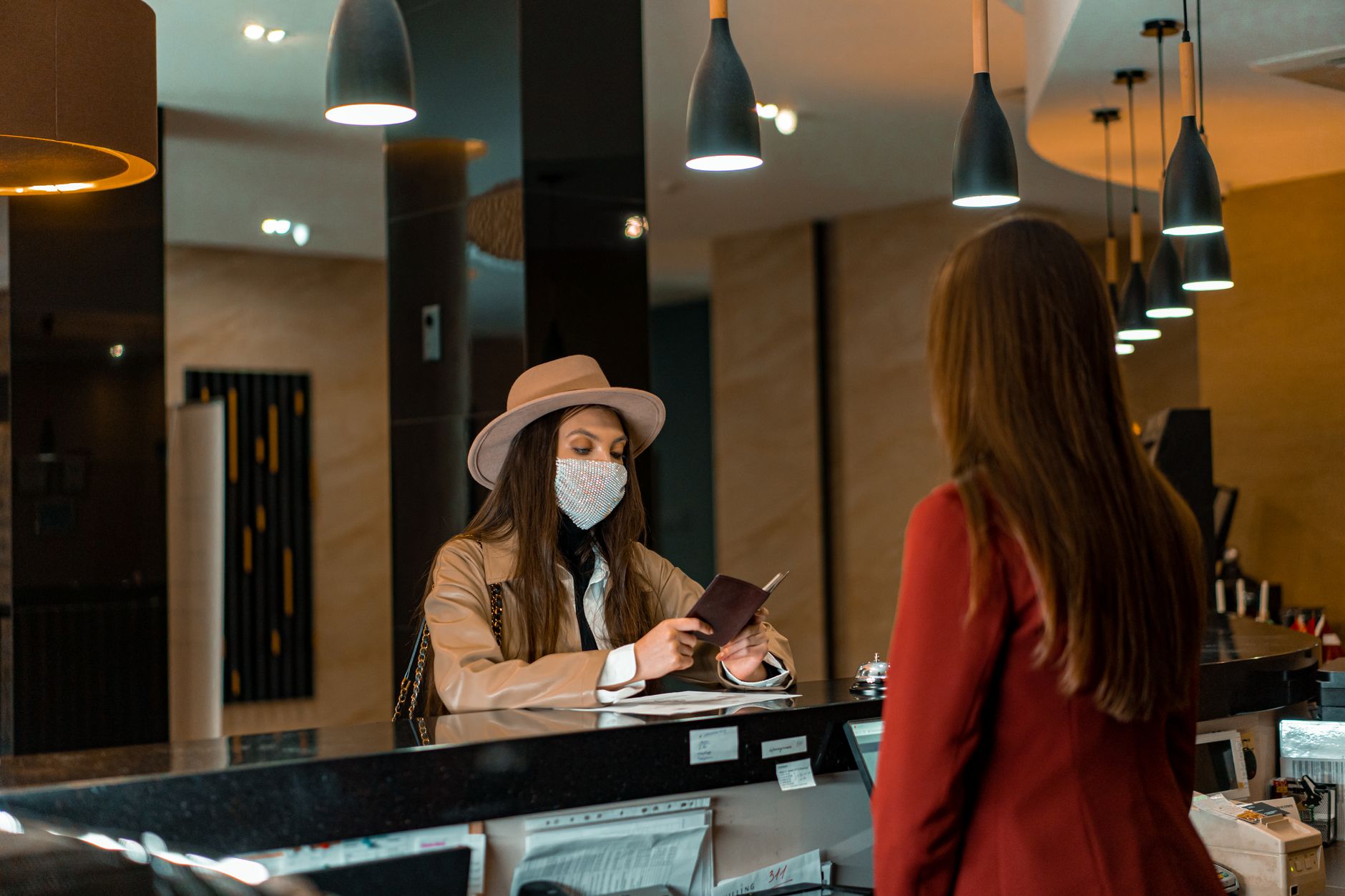 A gym owner greeting a new member at the reception desk