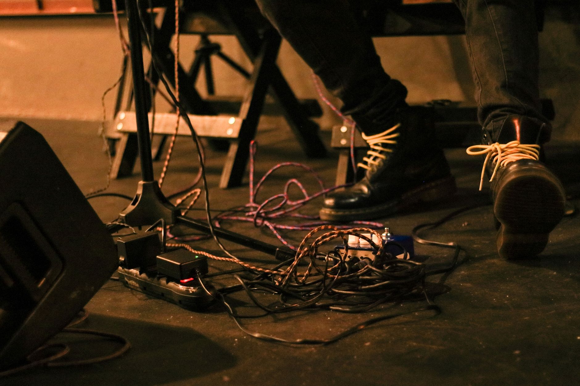 An independent musician setting up before a gig at a small venue