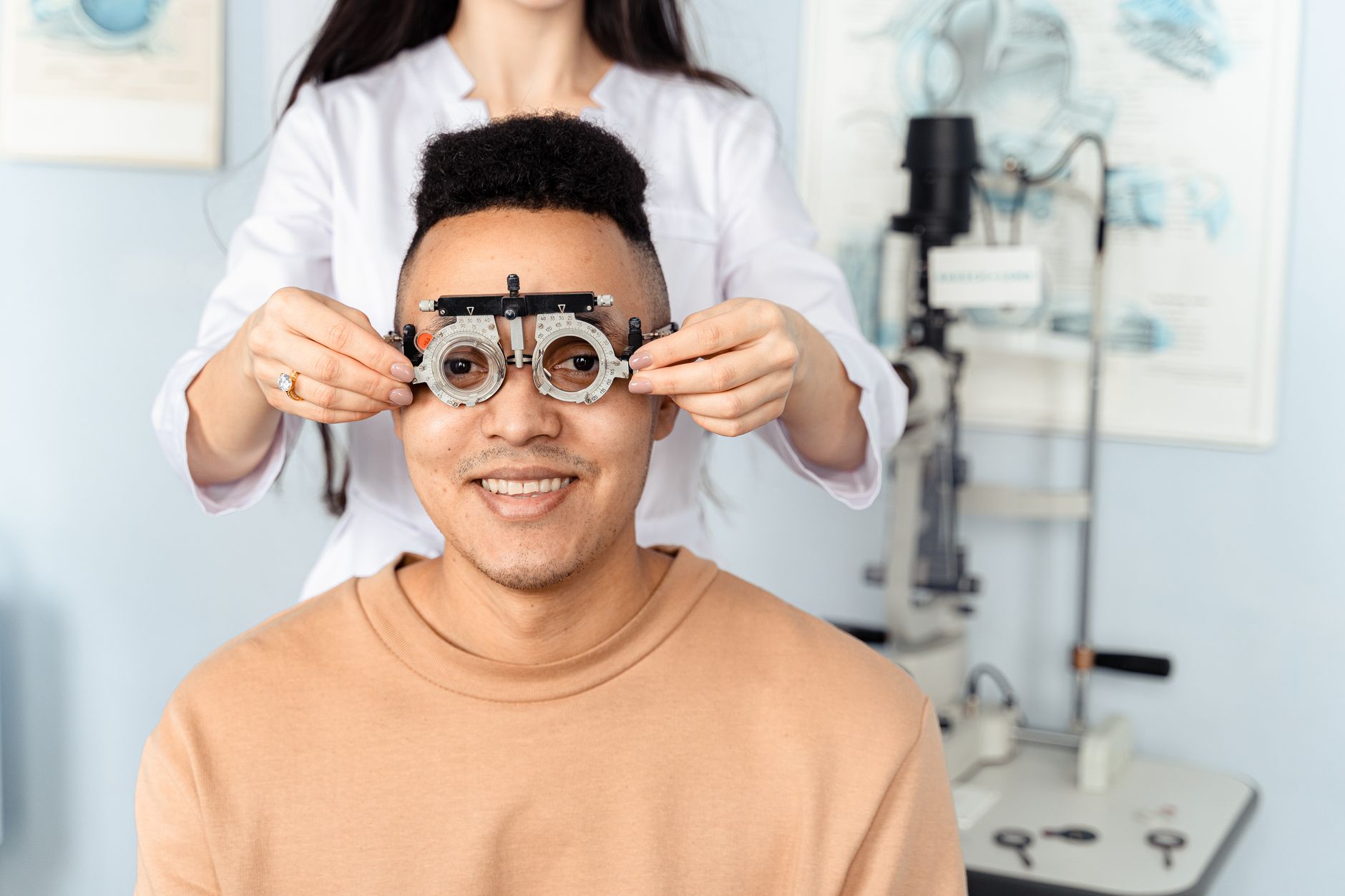 An optician carefully fitting a patient with new glasses