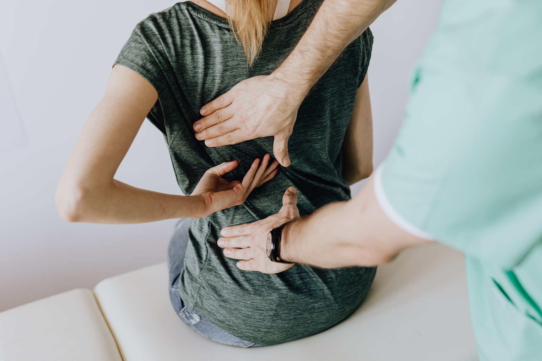 An osteopath treating a patient on a treatment table in a small practice