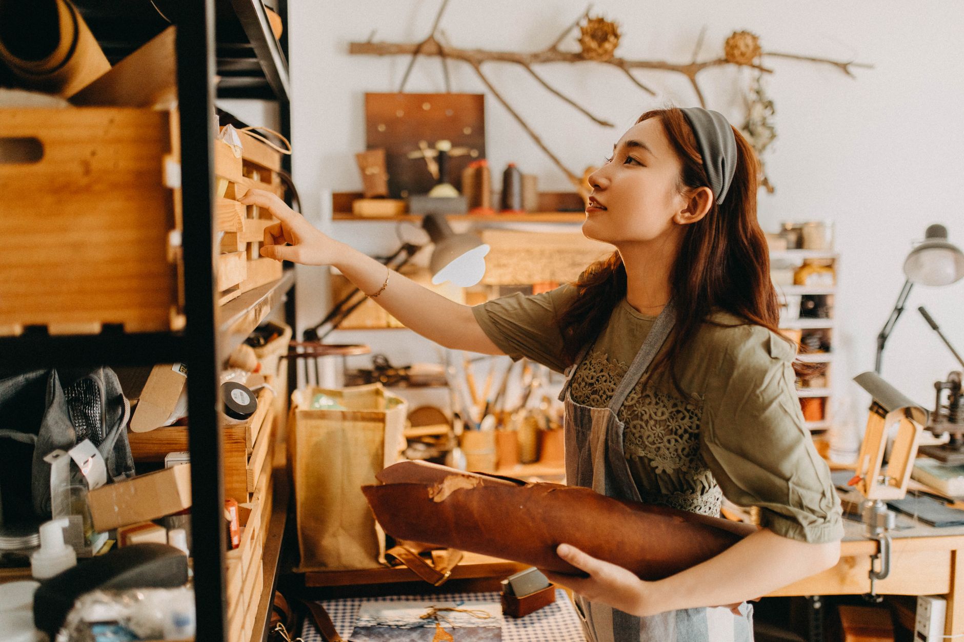 A creative business owner making work by hand in their studio