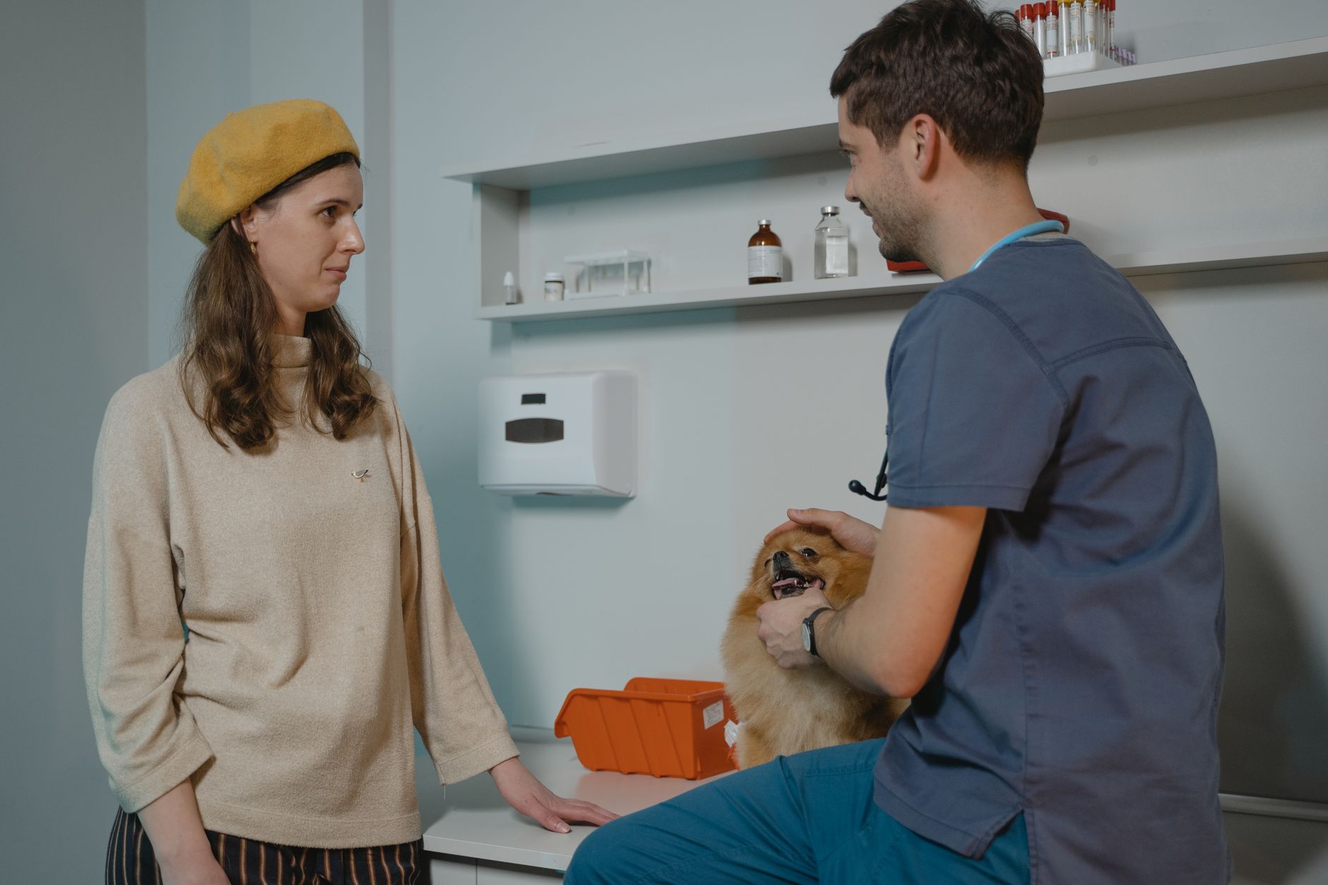 A vet practice receptionist welcoming a client and their dog