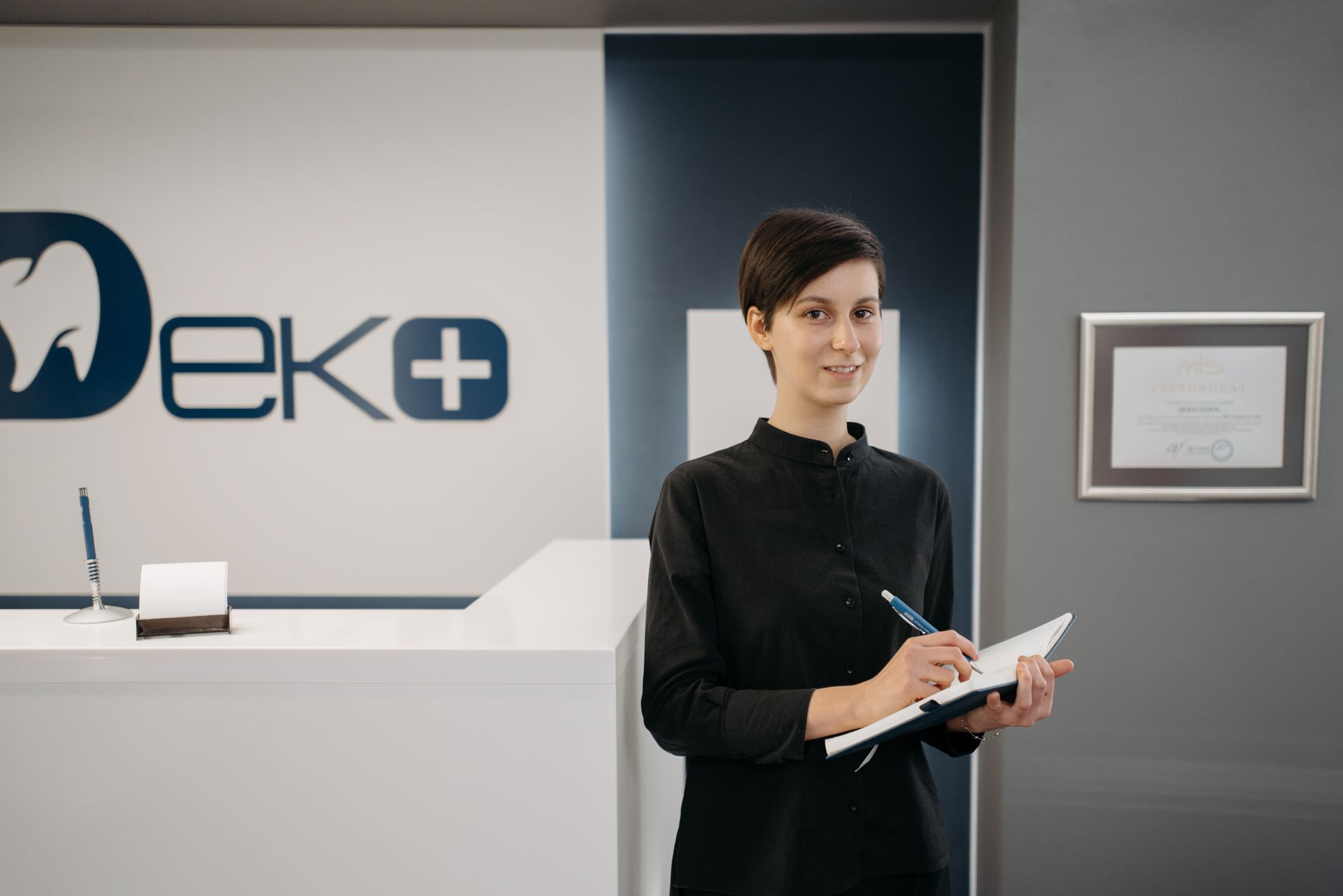 A health practice owner reviewing new branding plans at reception