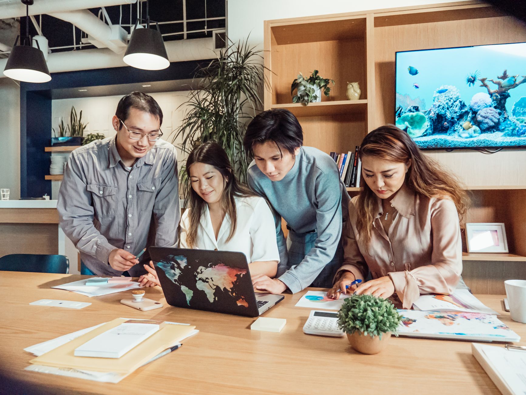 A small SaaS team reviewing new customer signups together