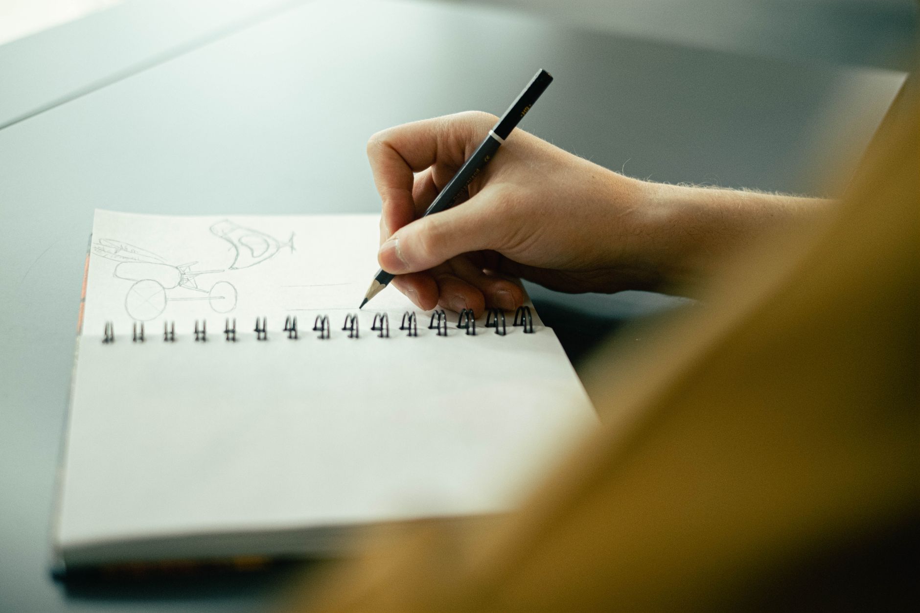 A creative business owner drafting a slogan in a sketchbook