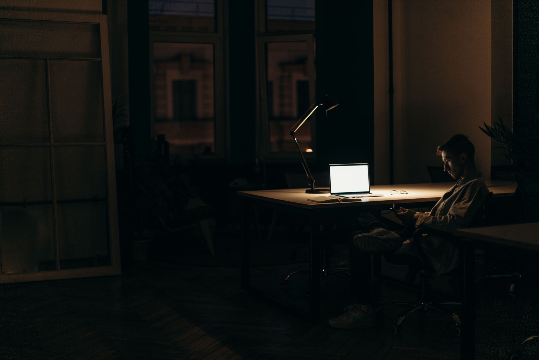 A small business owner working through their marketing after closing time