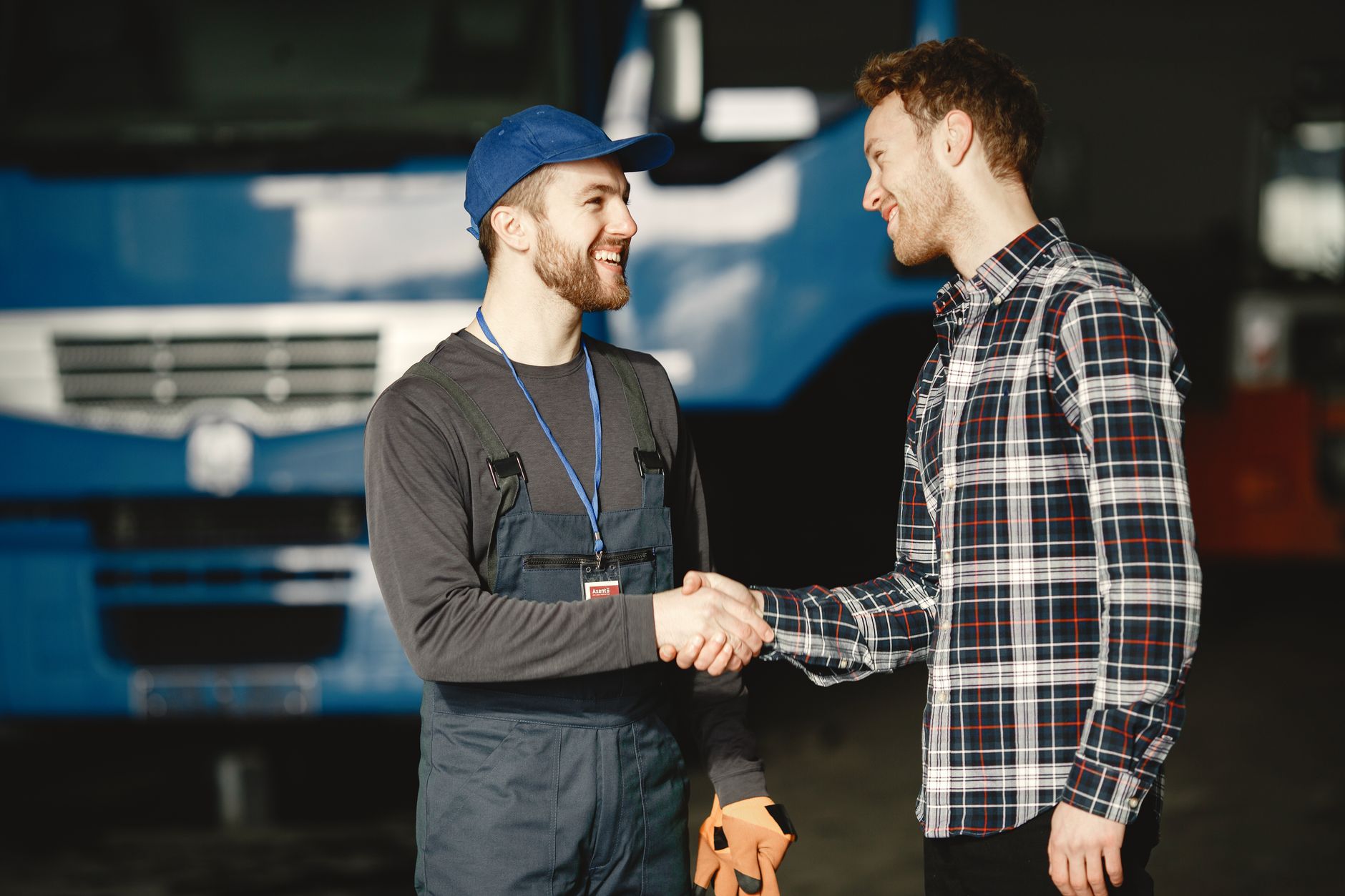 A tradesperson and a customer shaking hands after a completed job
