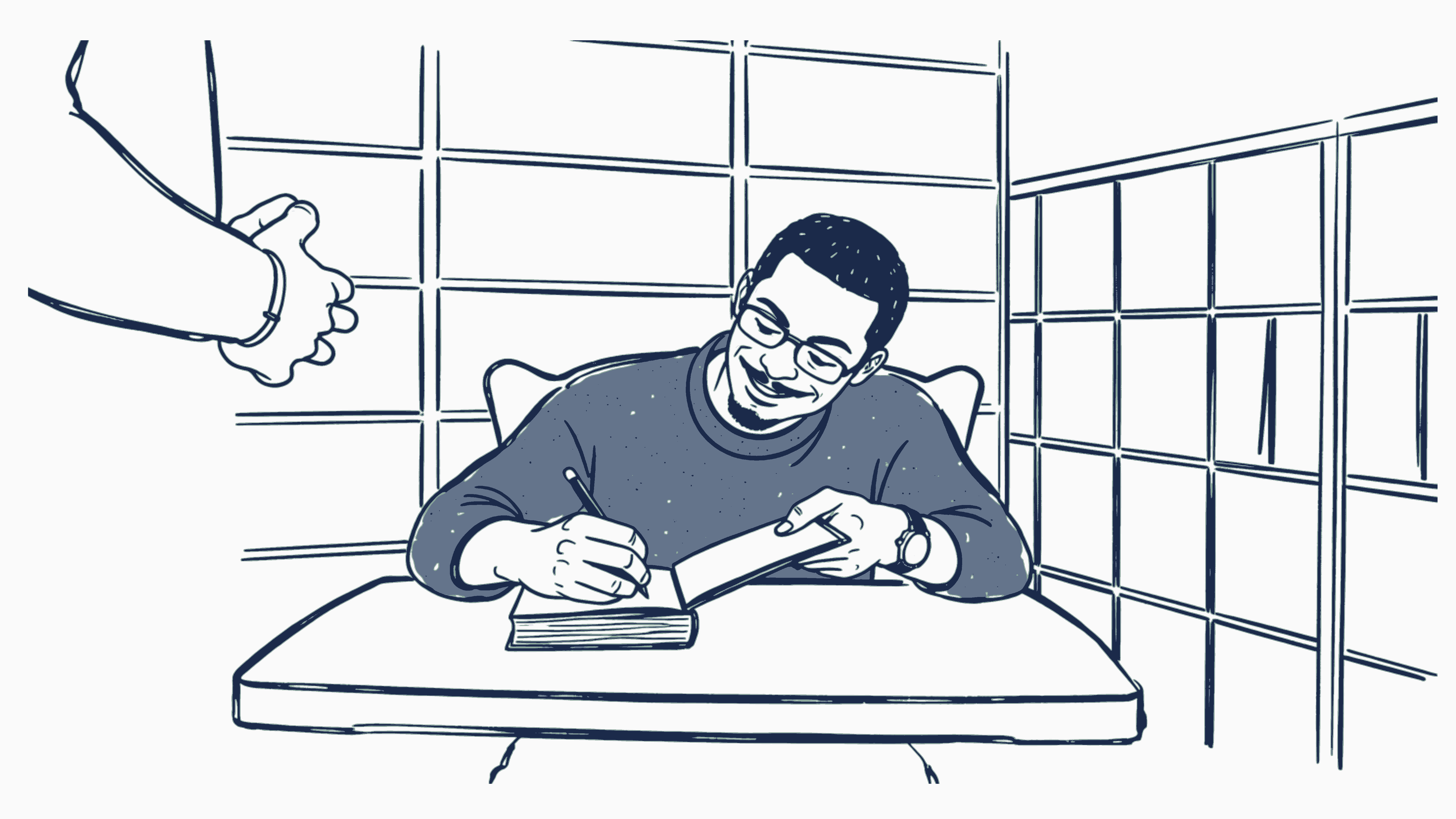 A writer working at a desk beside a window.
