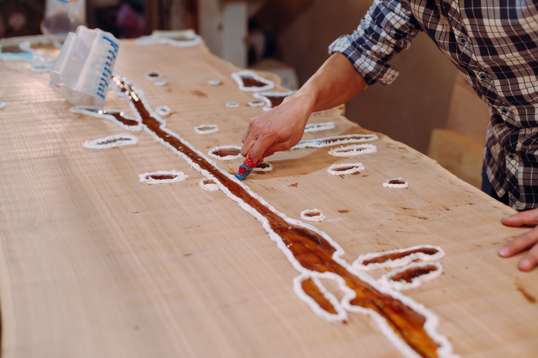 A furniture maker showing proof of finished work to a customer