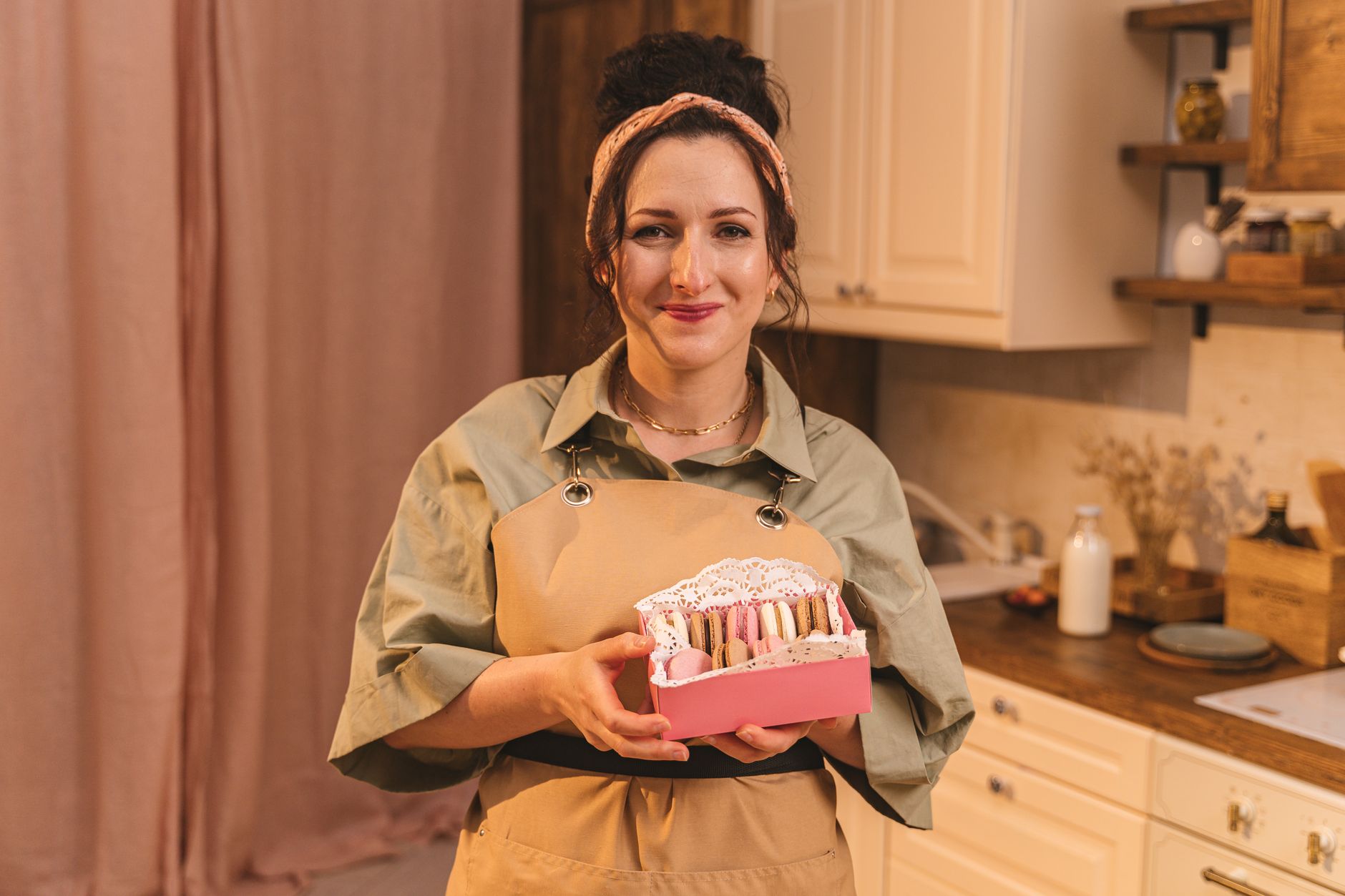 A baker assembling a festive gift set of small treats