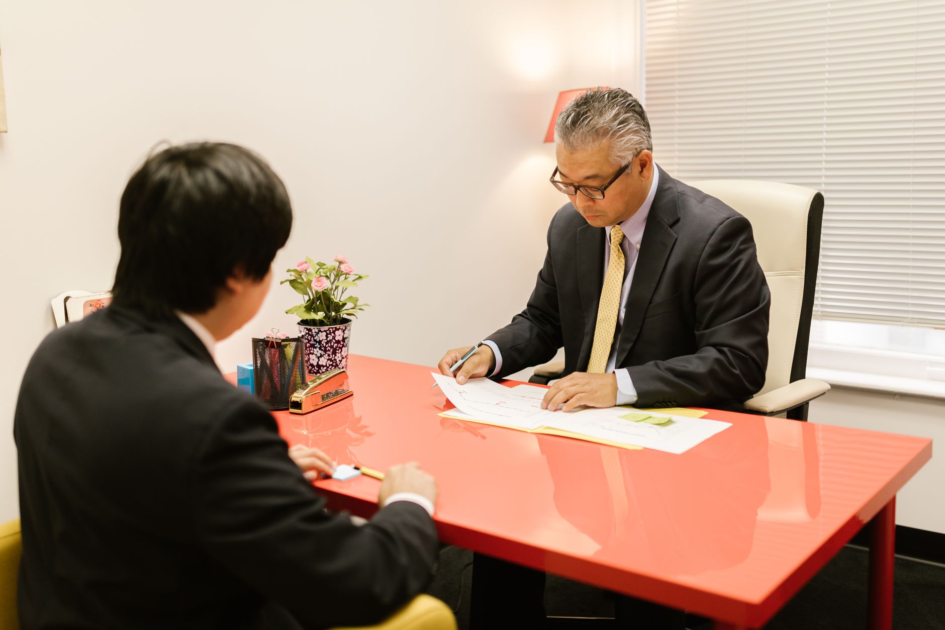 Two colleagues comparing a templated email against a freshly written one