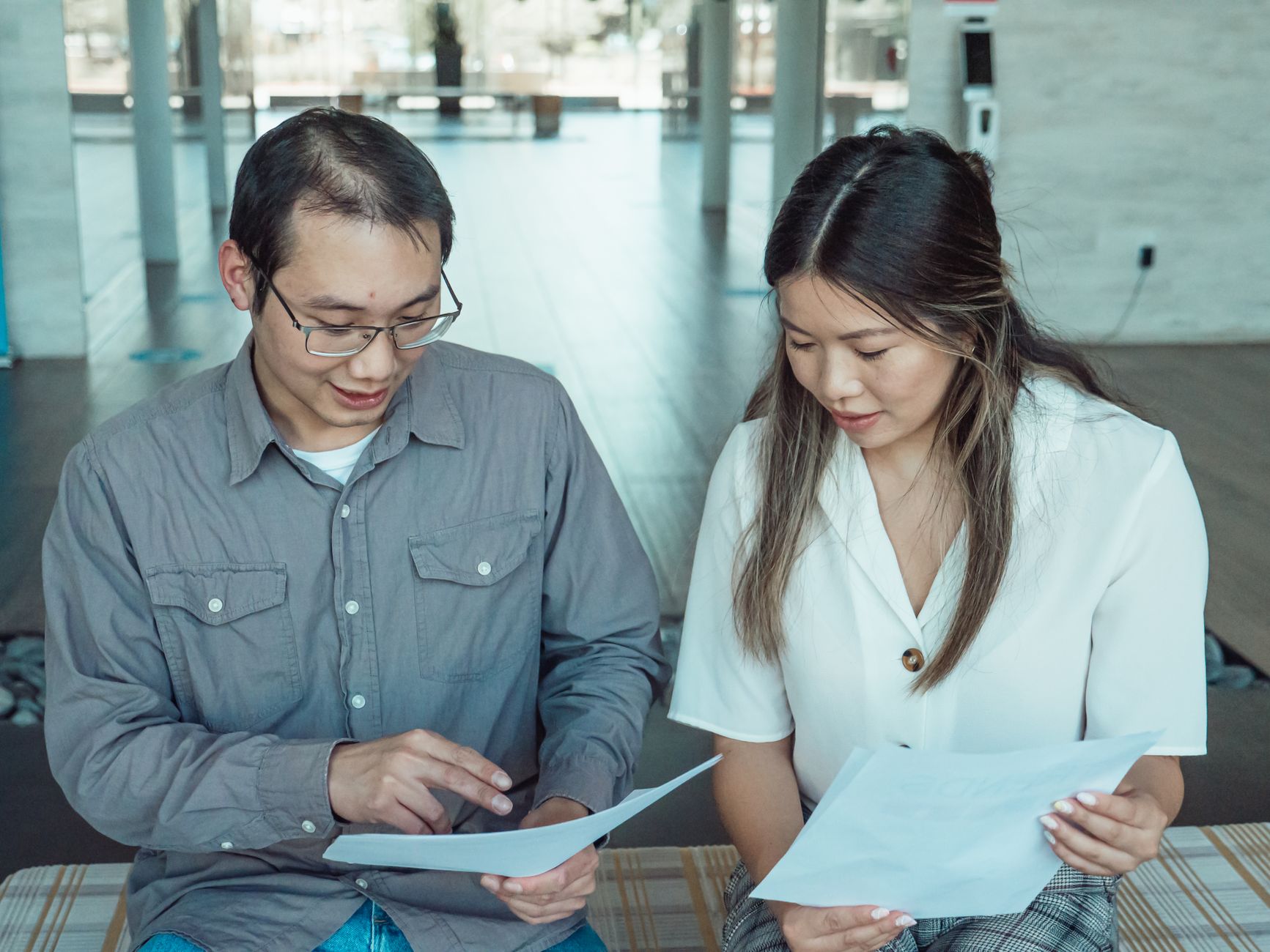 Two people reviewing a consultancy proposal together