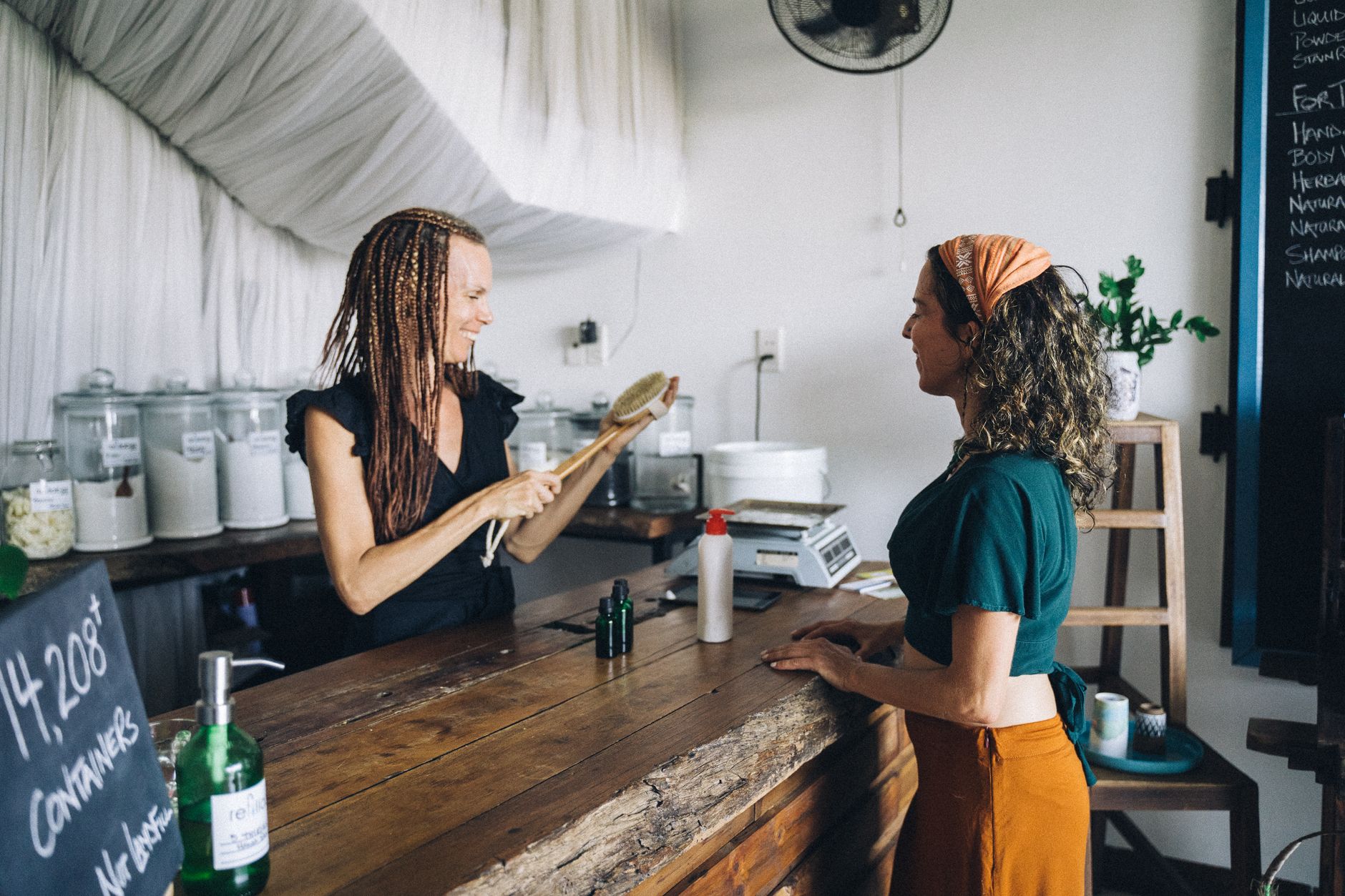 A shop owner helping a customer who found them through a recommendation