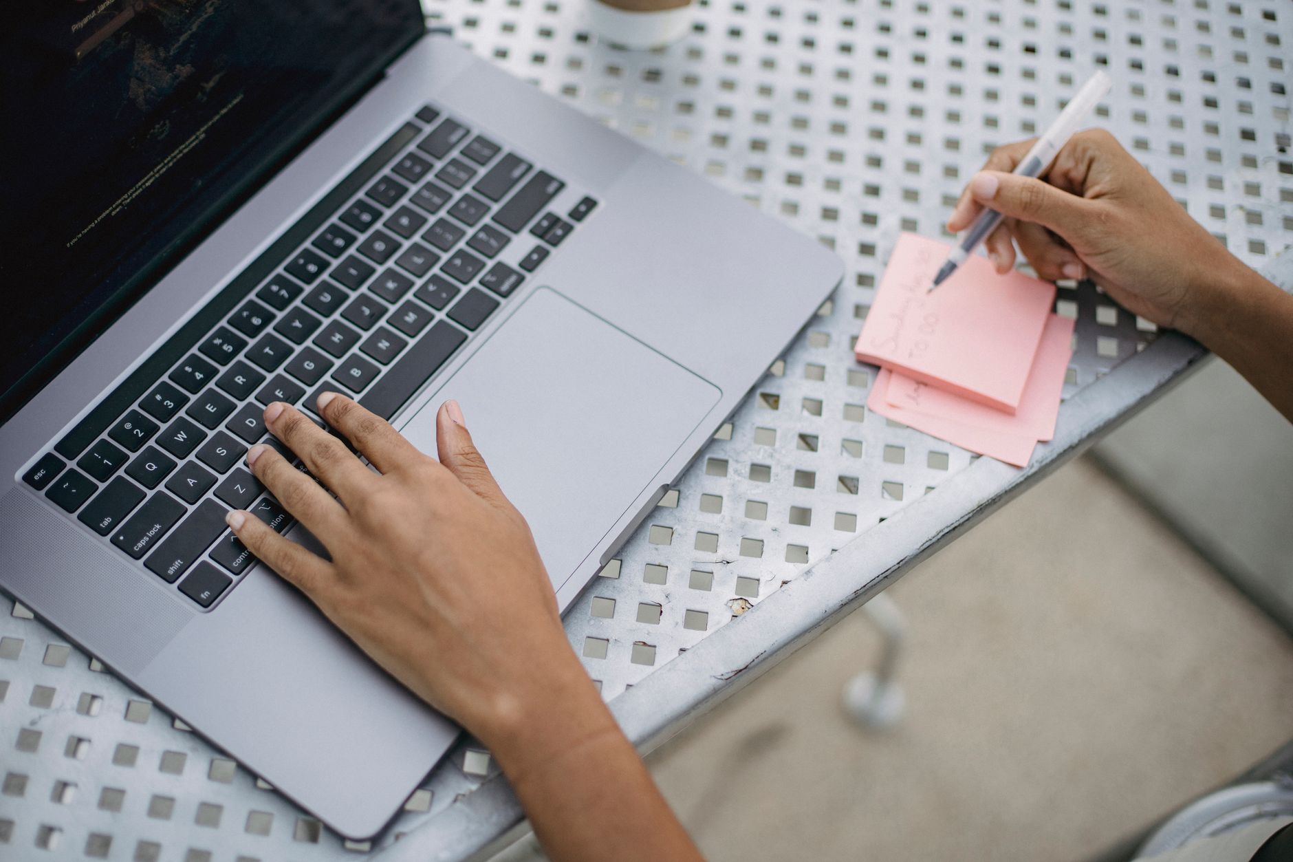 An owner writing clear answers to customer questions for their website
