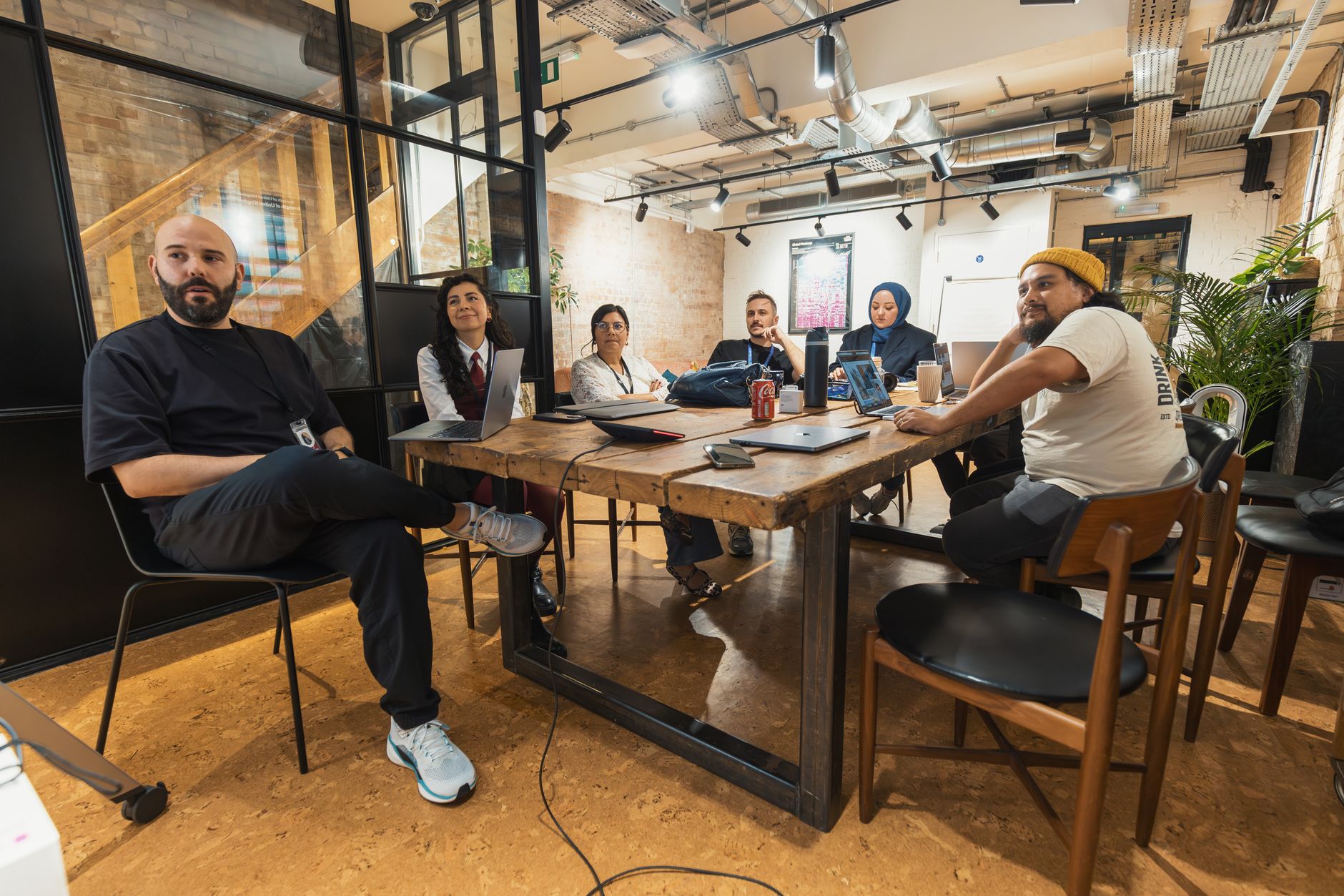 A small group of colleagues weighing a business decision together around a table