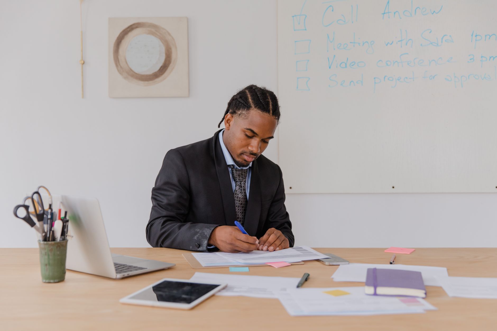 A business owner writing out their ideal customer in a notebook at a desk