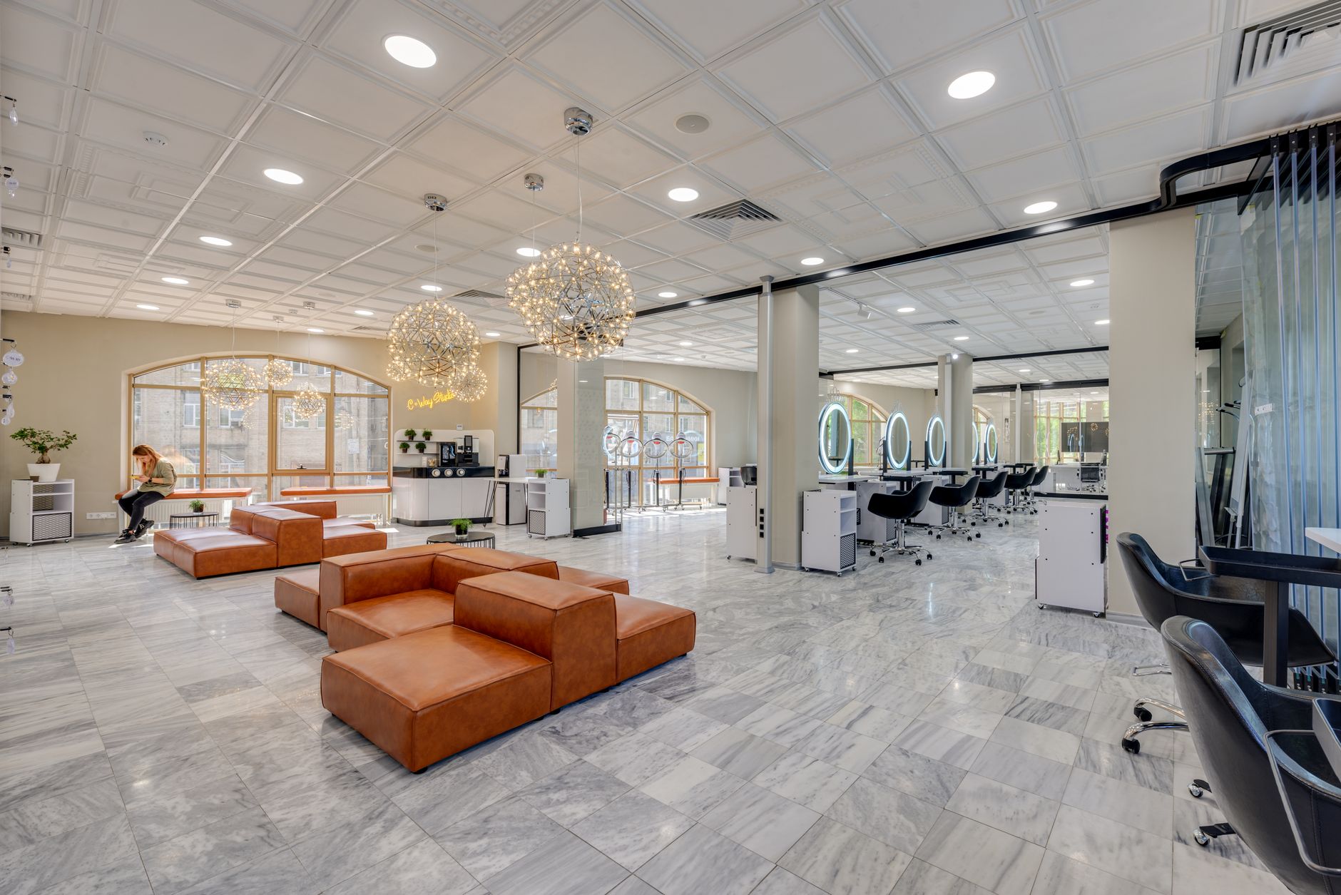 A busy beauty salon reception with clients waiting for appointments