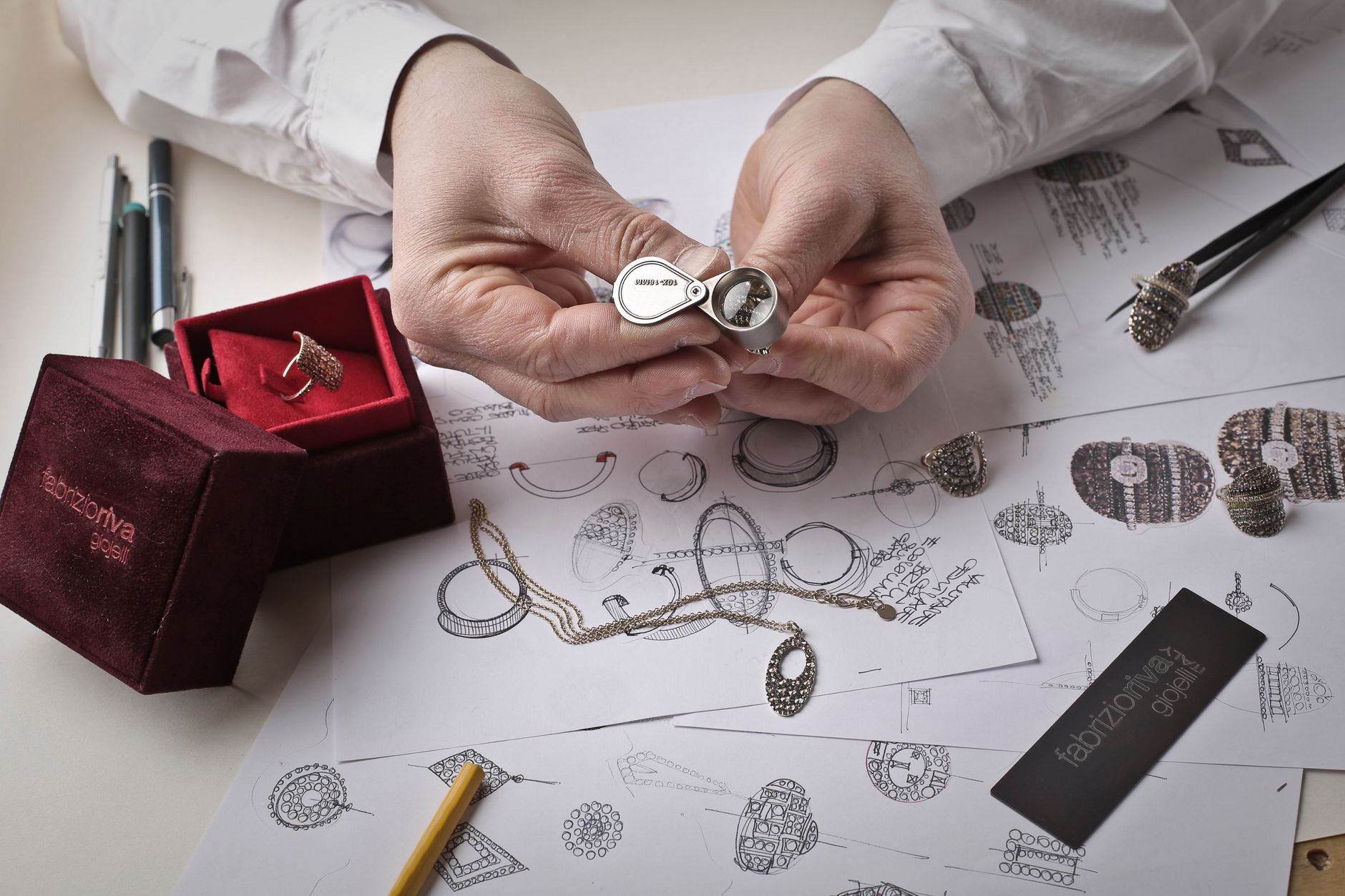 A jeweller carefully setting a gemstone under magnification