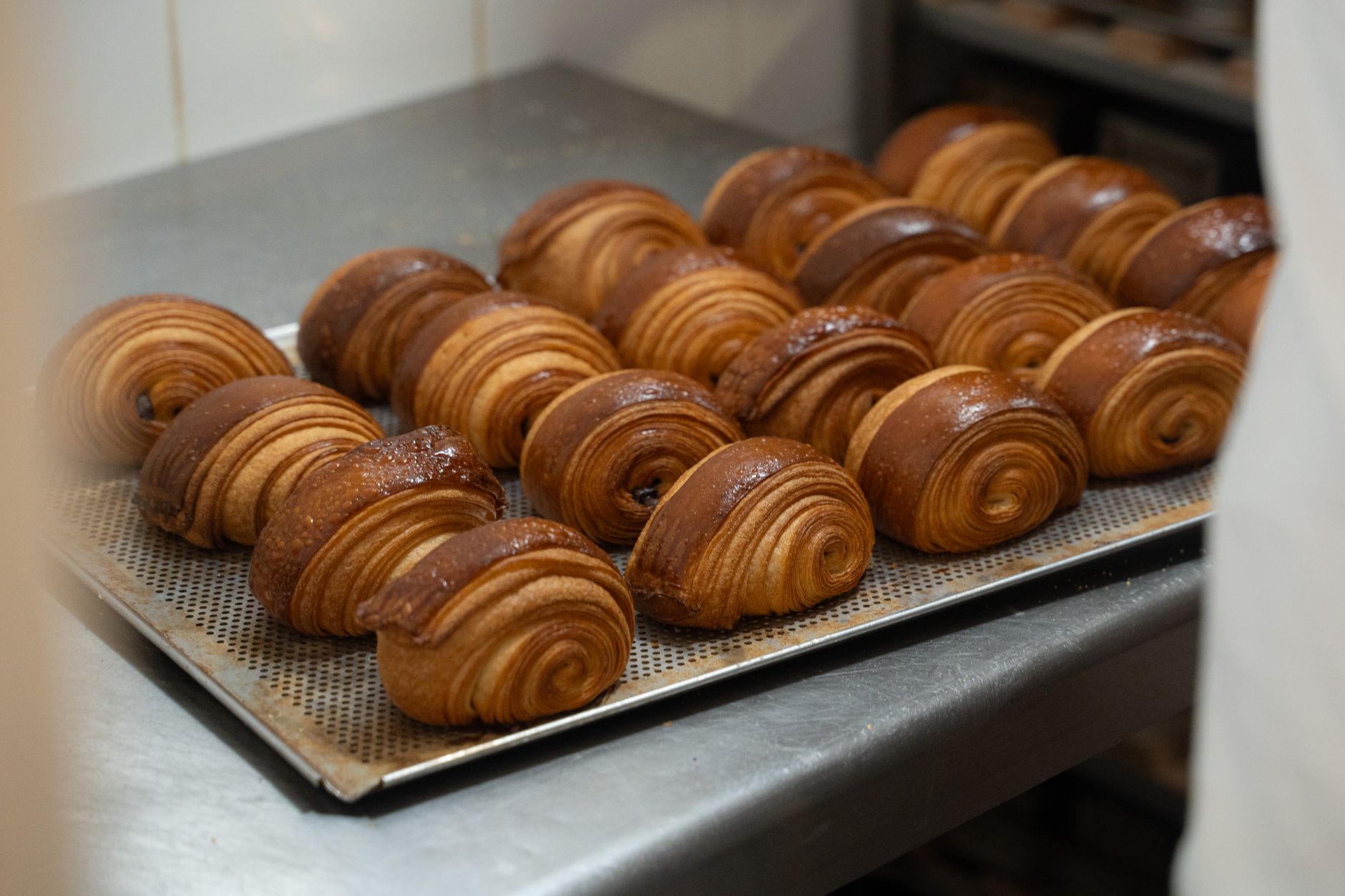 A cafe owner taking a photo of the day's bakes for social media