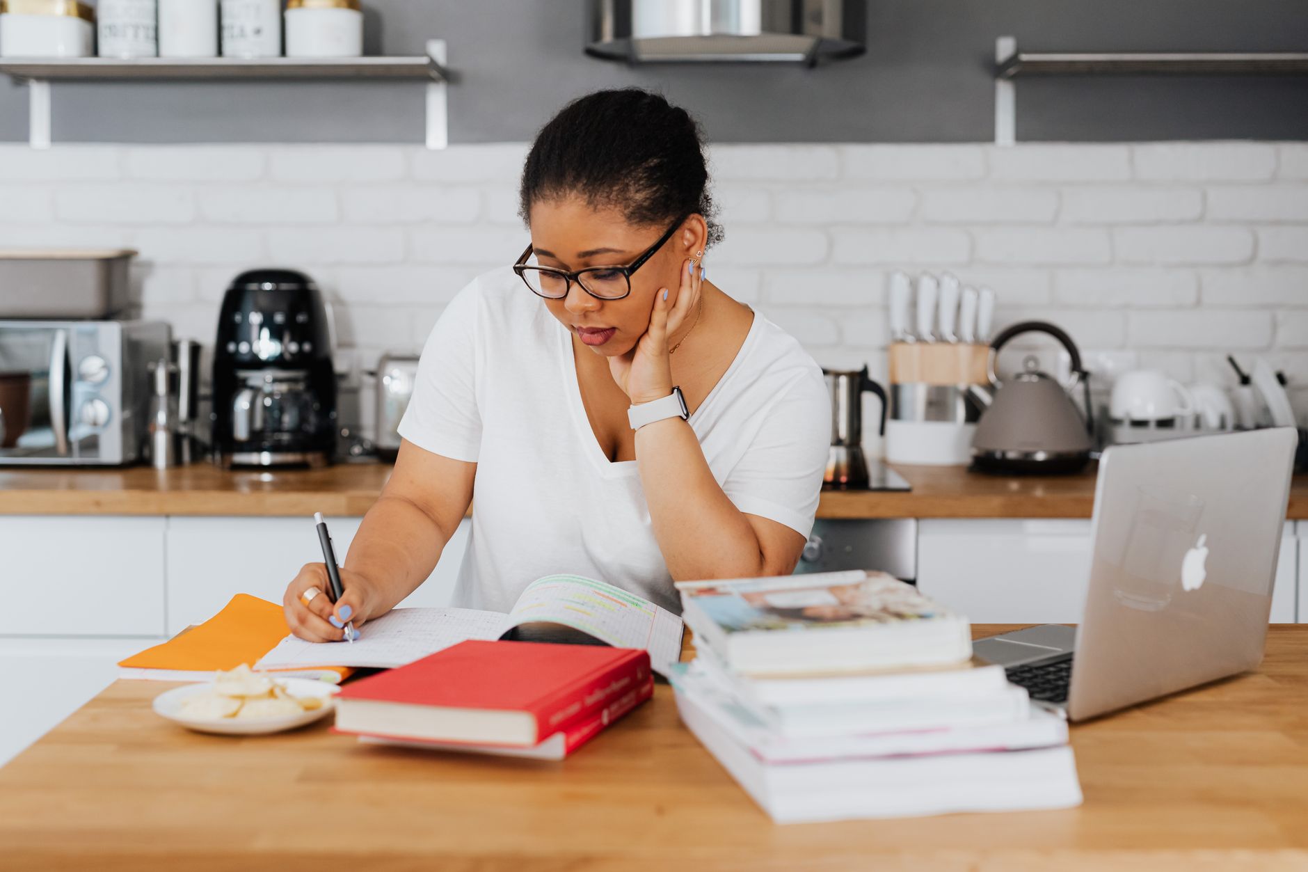 A course creator planning blog topics at their kitchen table