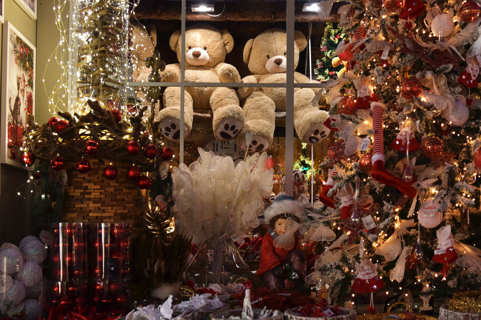 A shop owner swapping a Christmas display for new season stock
