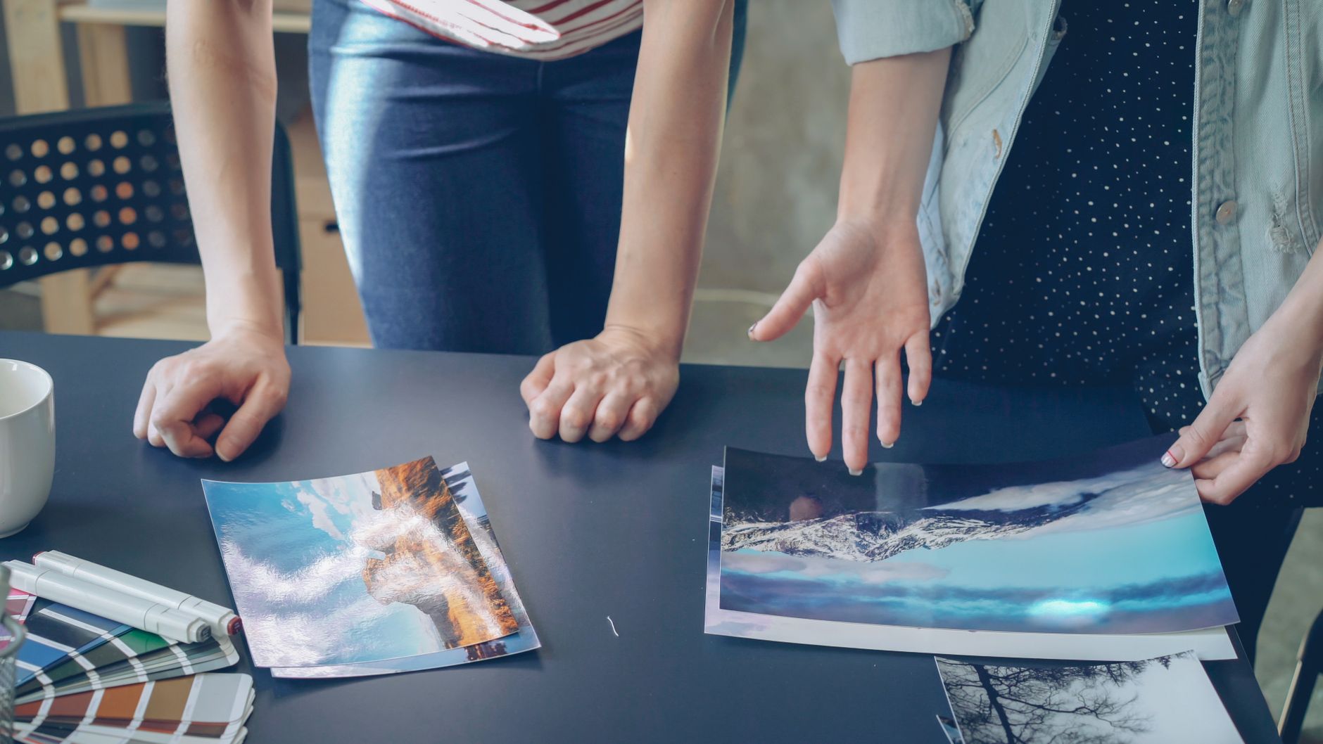 A small design studio team reviewing a set of brand guidelines together