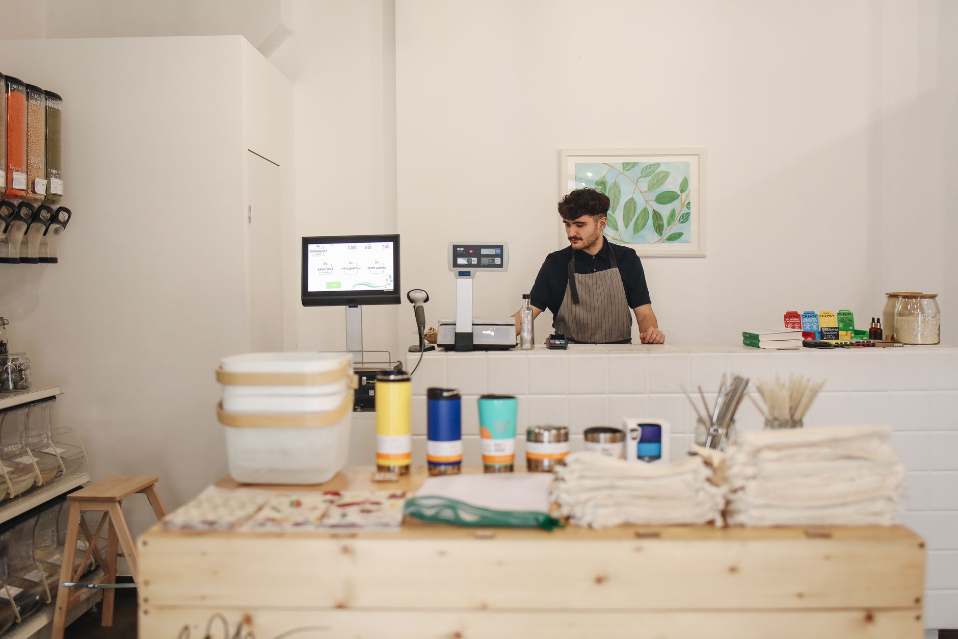 A shop owner arranging consistently branded packaging on the counter