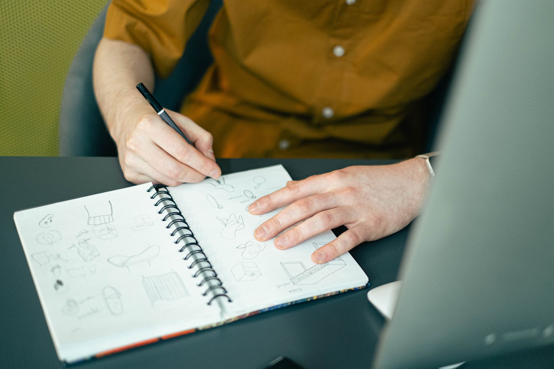 Two colleagues sketching their brand personality in a notebook