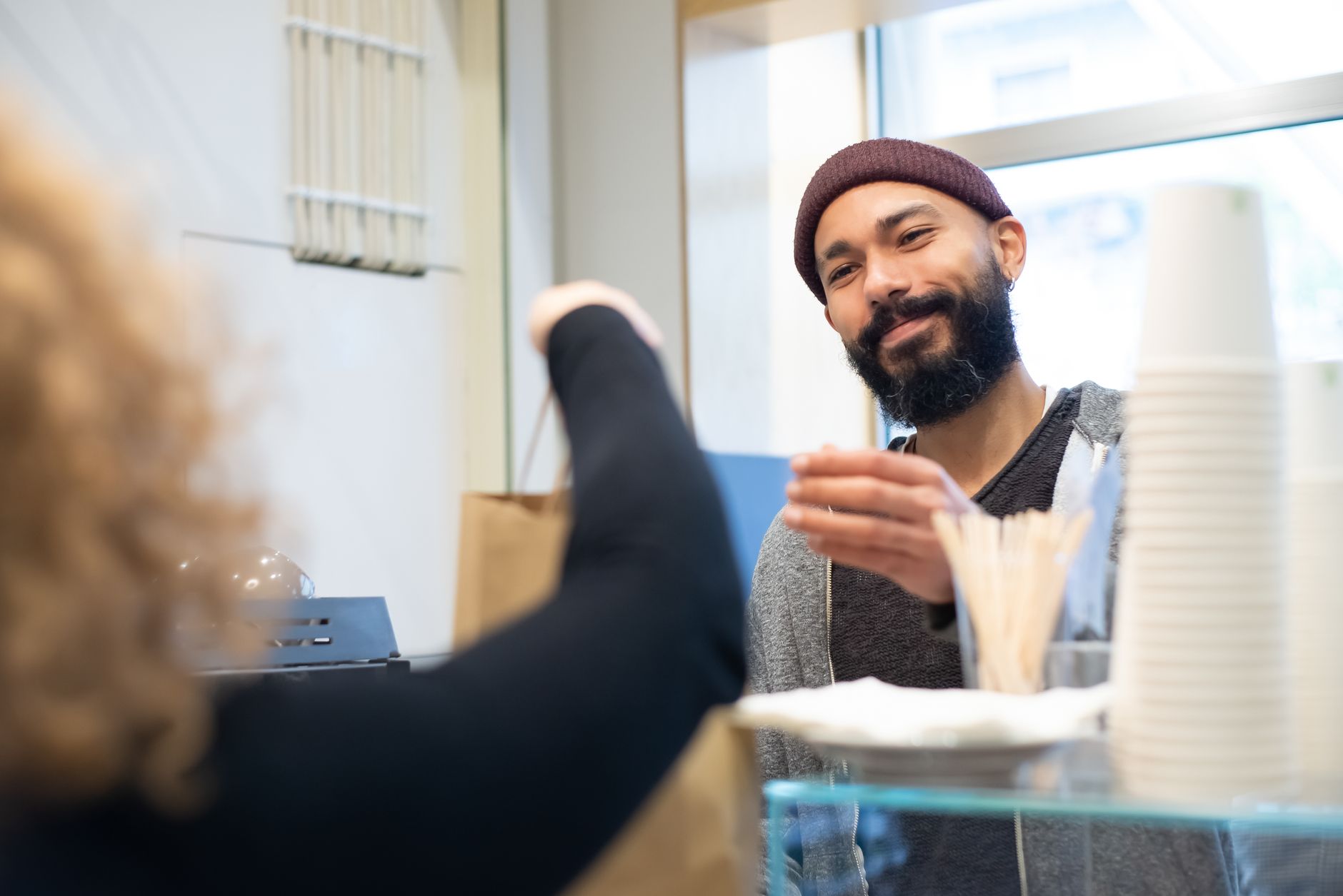 A shop owner delivering on the brand promise with a happy customer
