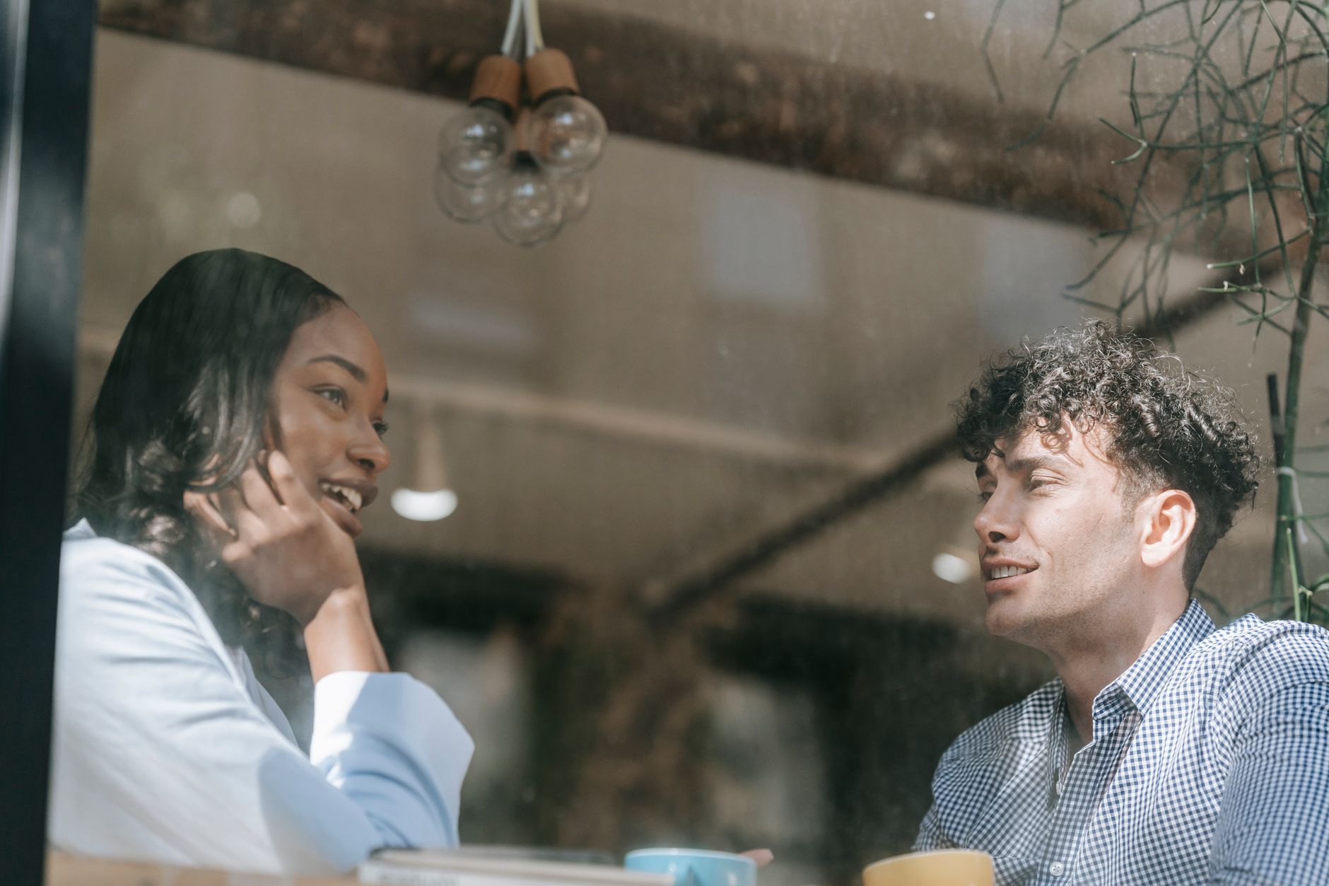 One friend recommending a small business to another over coffee
