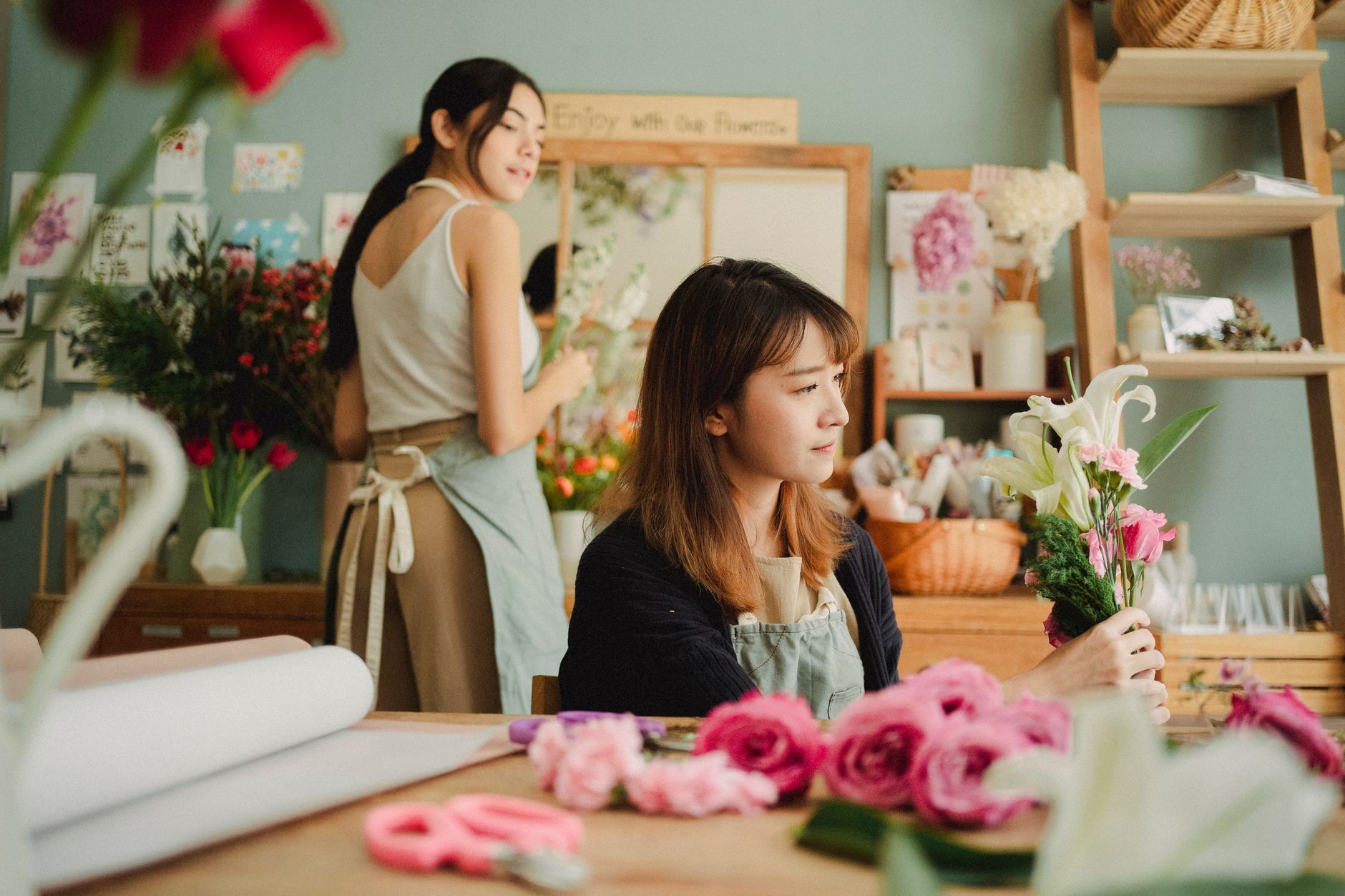 A wedding florist creating an arrangement in her signature style
