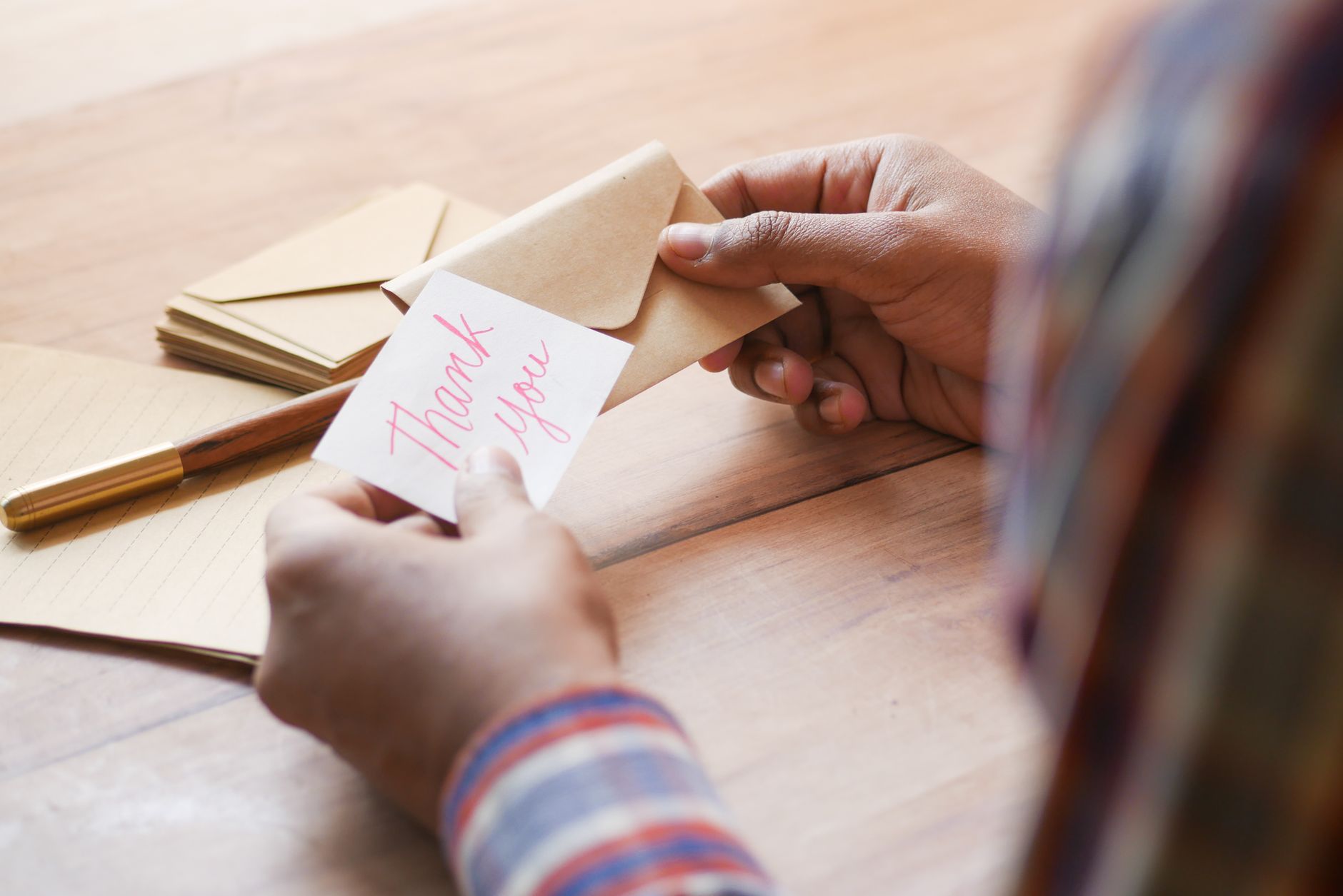 A business owner reading a note of thanks from a loyal customer