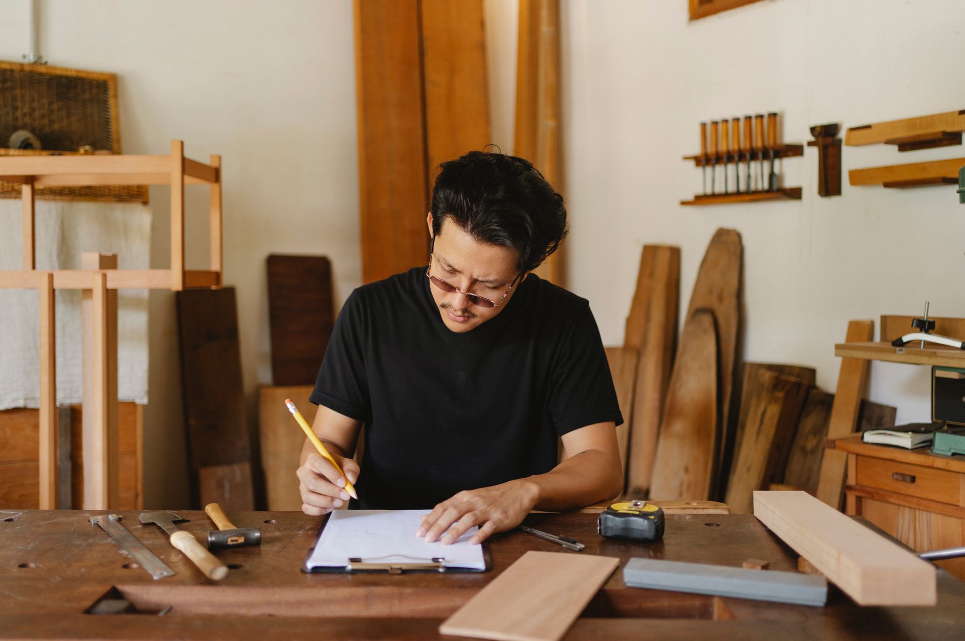 A creative business owner writing in their own voice at their workbench