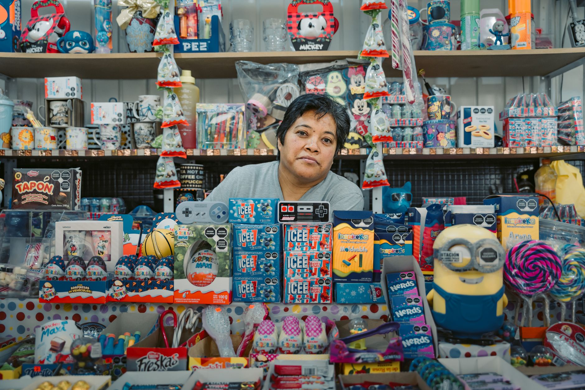 A shopper browsing a Christmas gift display in a small shop