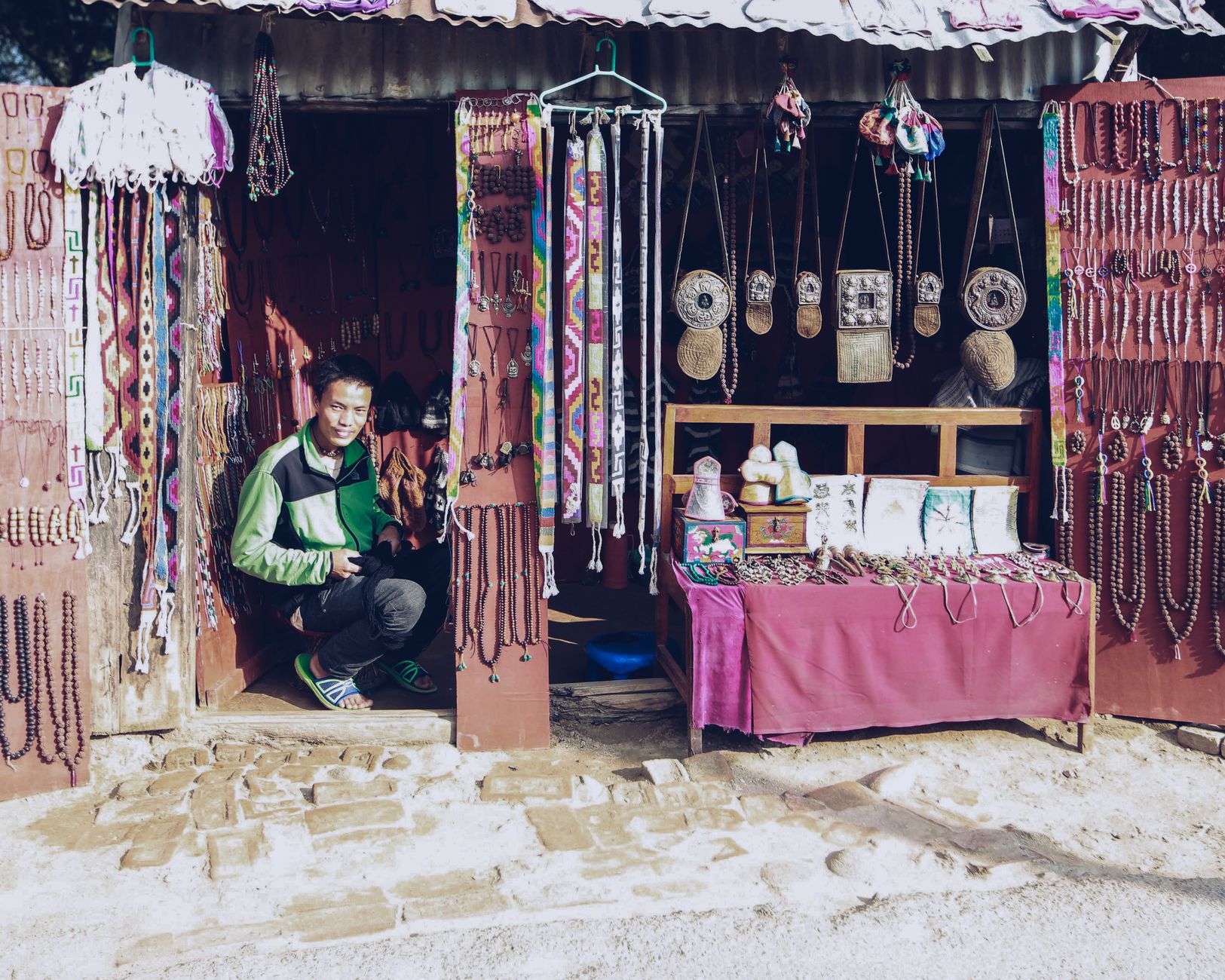 A shop owner arranging gifts for a Christmas display