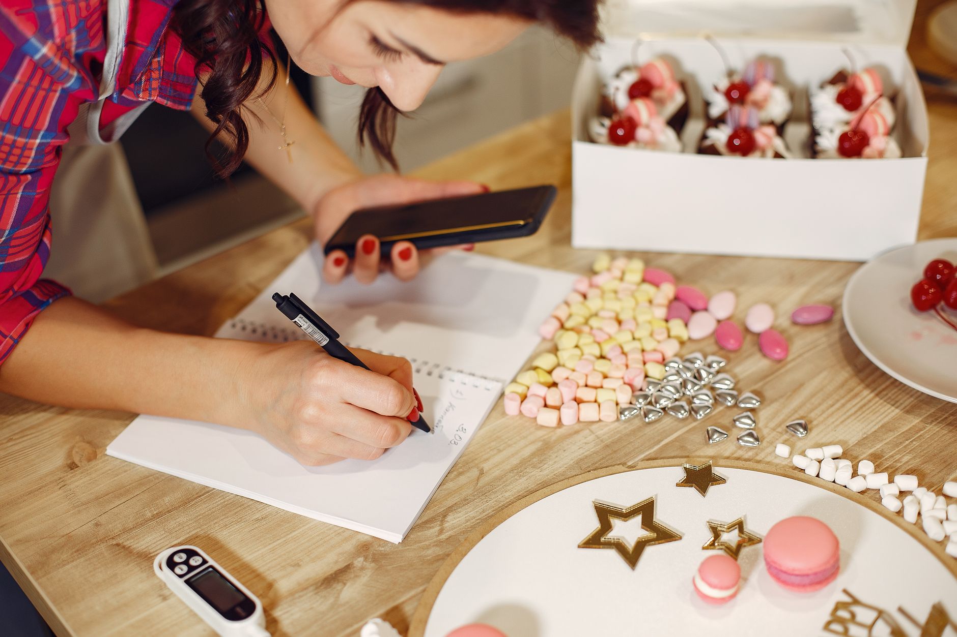 A small business owner planning their Christmas marketing in a notebook