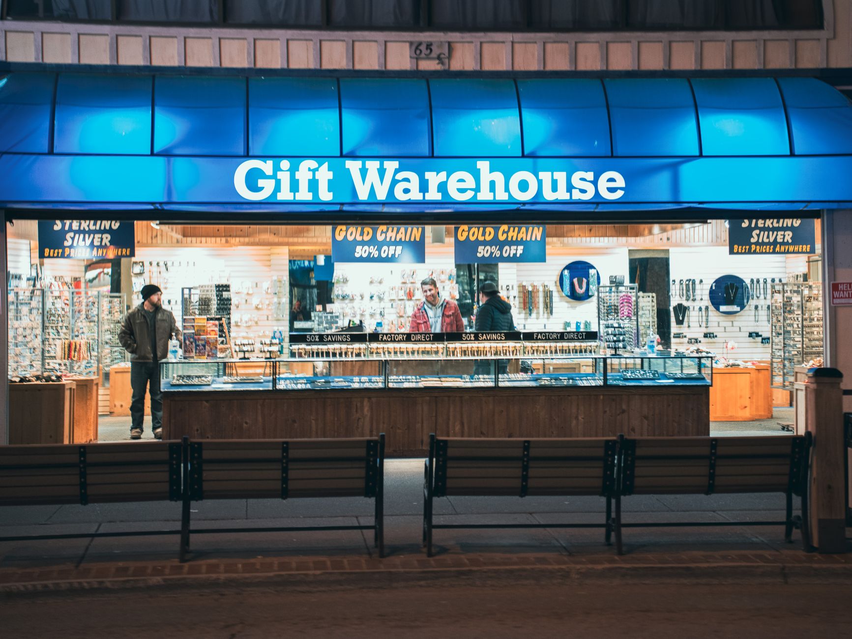 A customer browsing a festive window display in early autumn