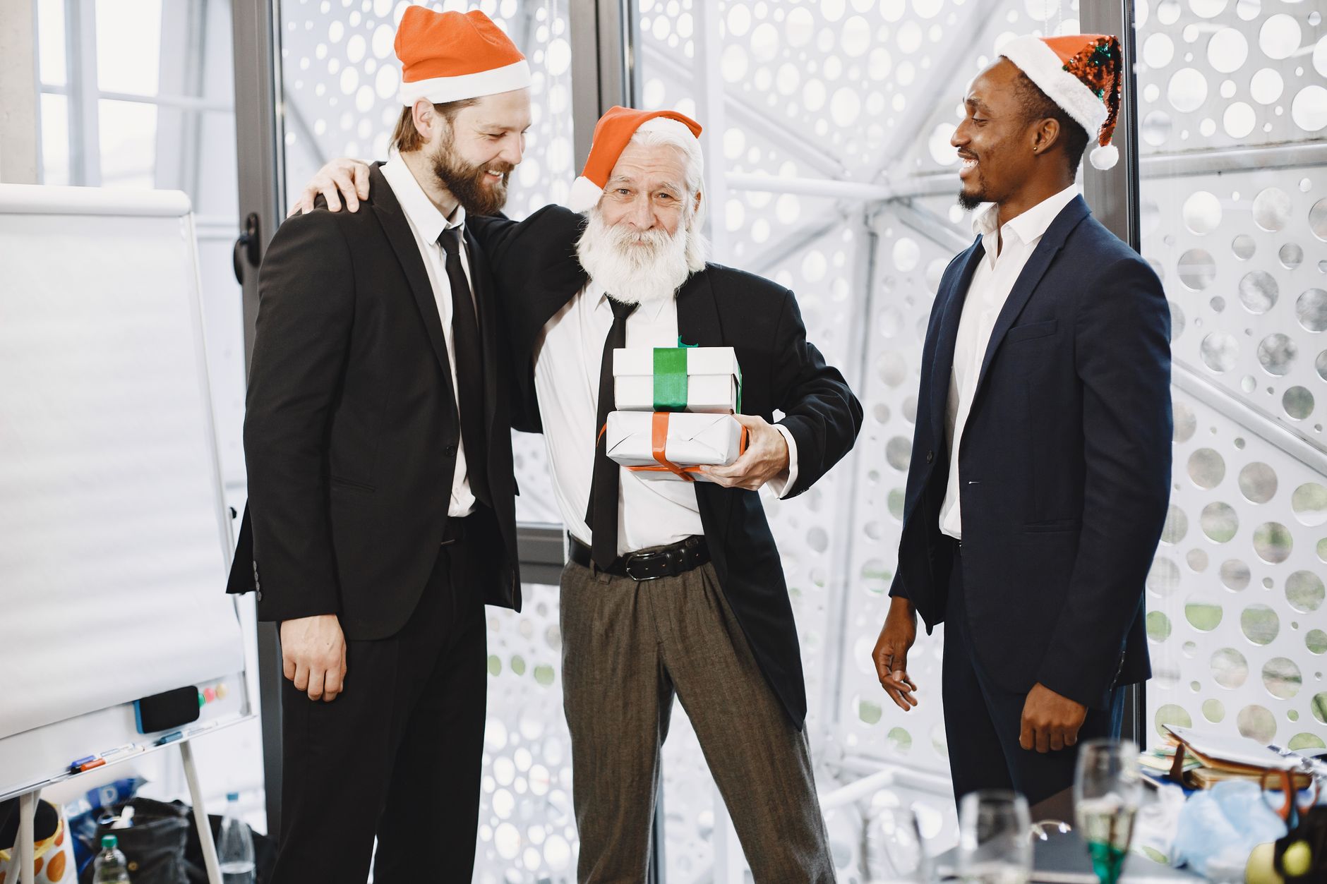 Two colleagues choosing a Secret Santa gift together in a shop
