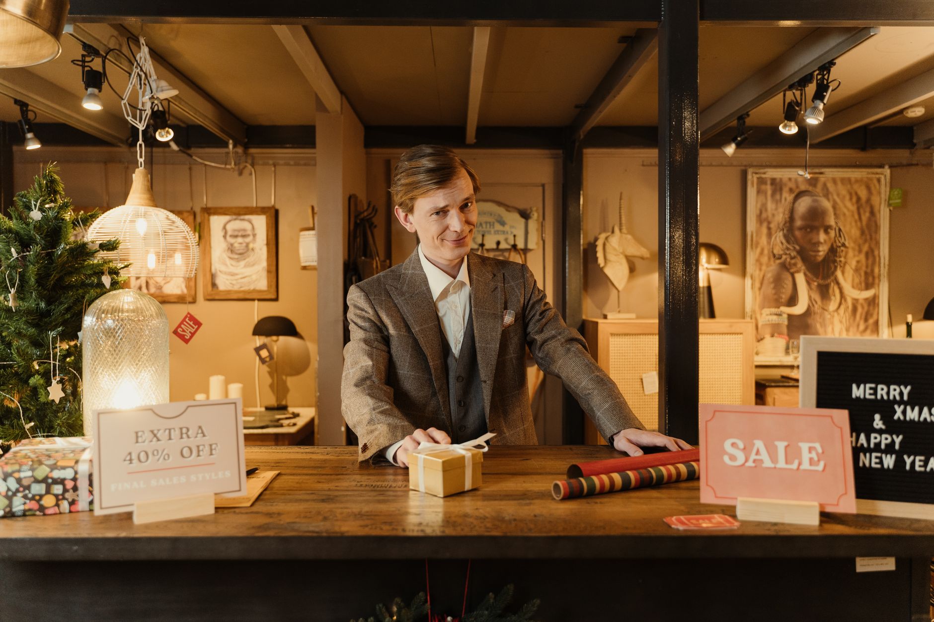A small shop owner wrapping gifts ready for the Christmas season