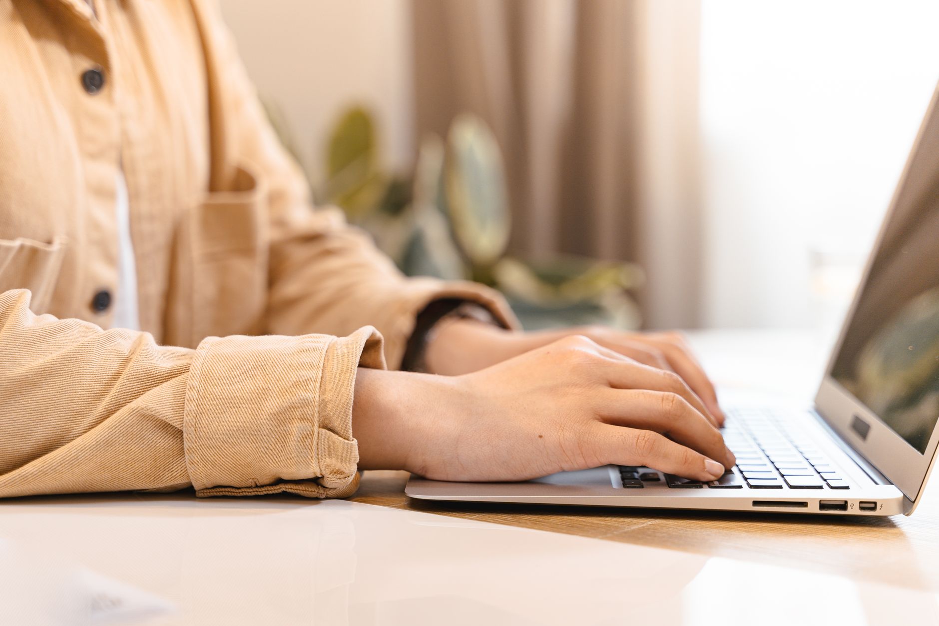 A business owner typing a short, specific email subject line
