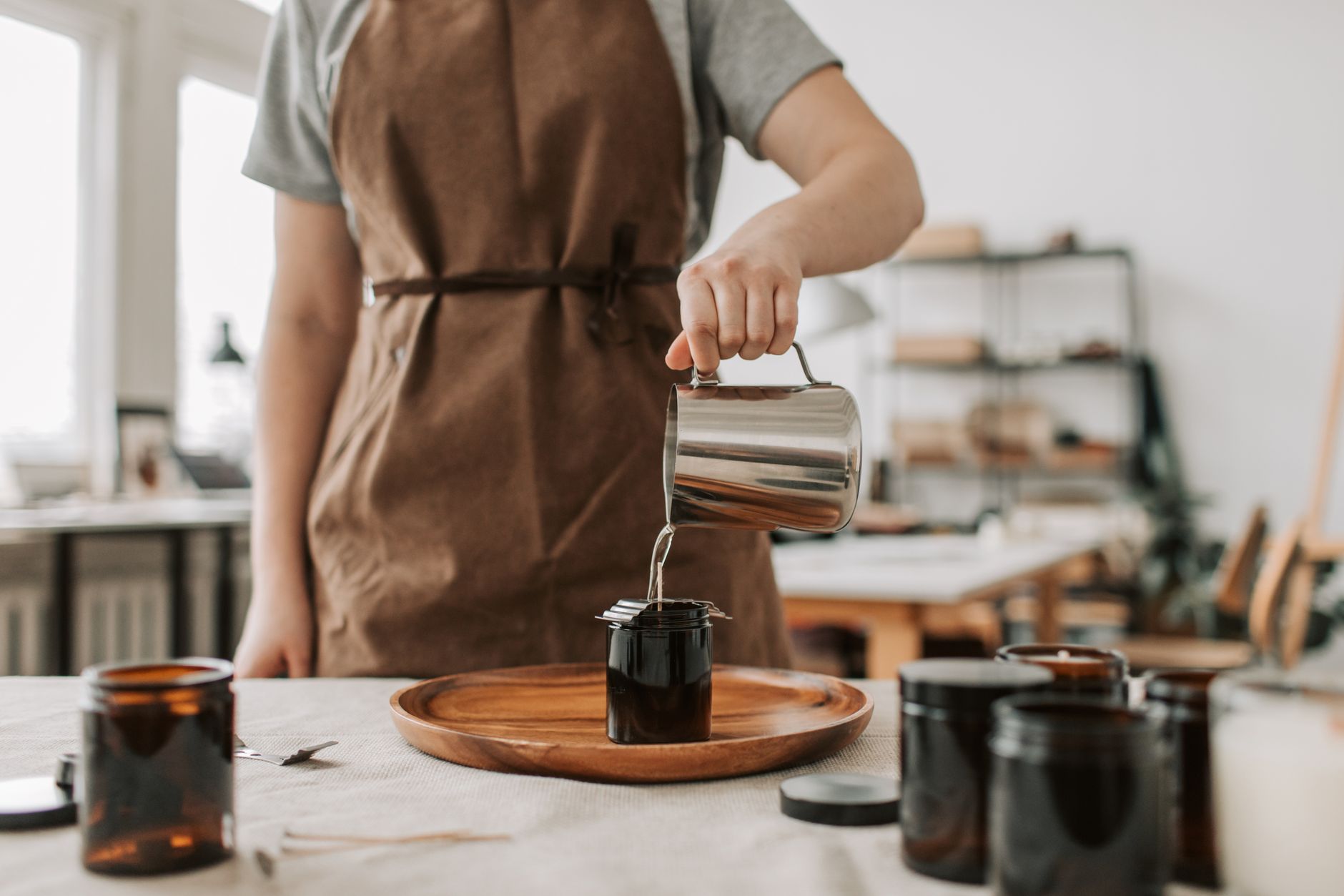 A candle maker preparing a new batch of stock for a planned launch