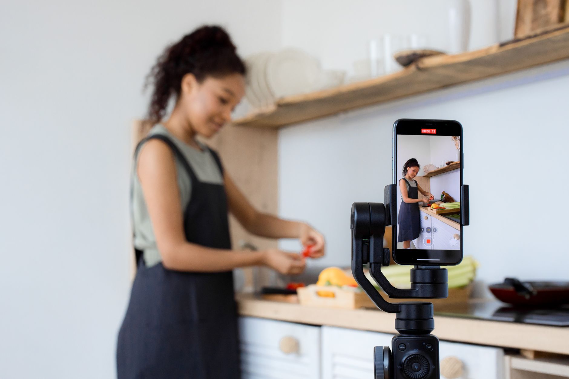 A tradesperson filming a short, helpful how to video with a phone on a stand