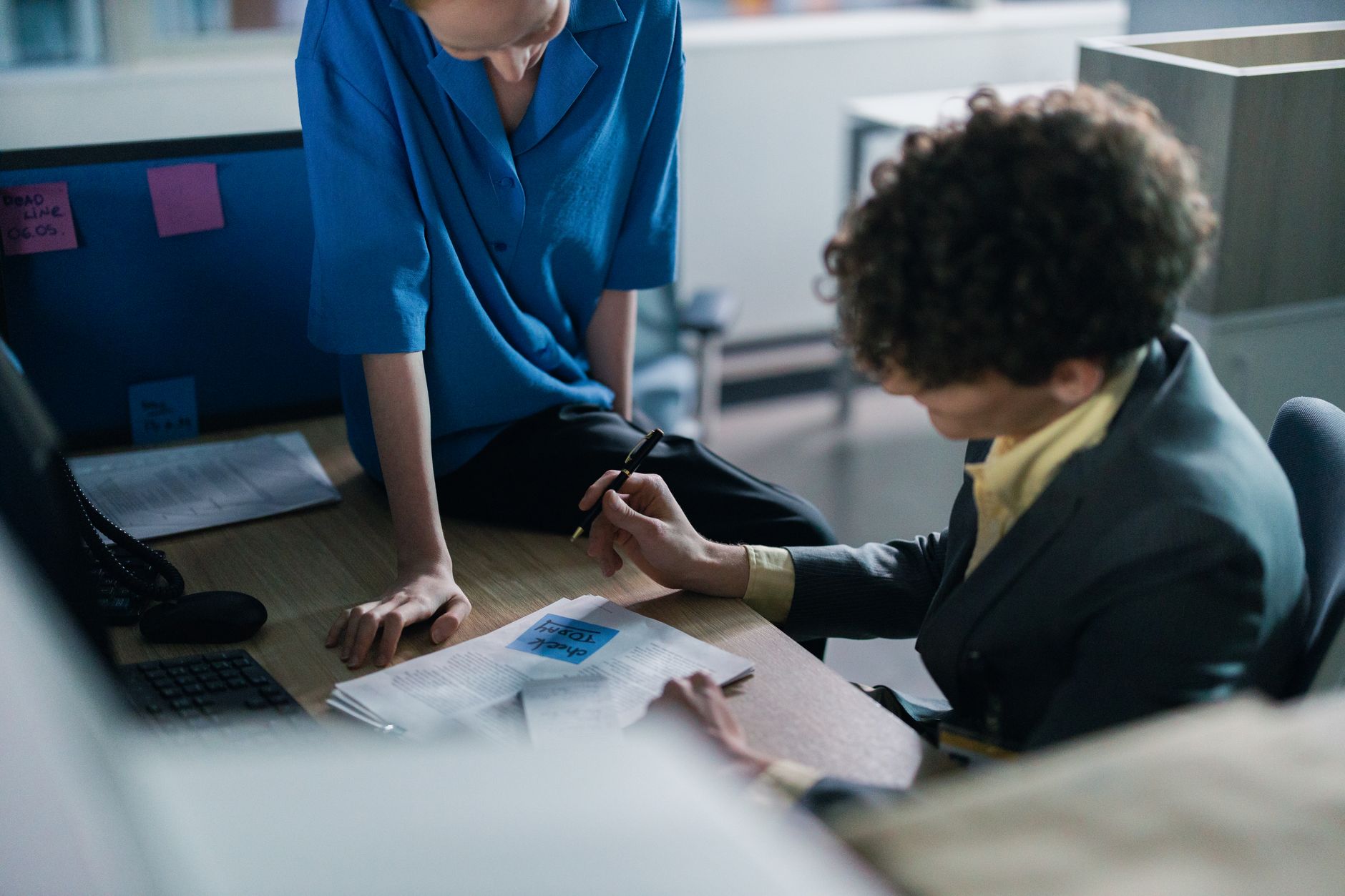 Two colleagues reviewing how their content is performing at a desk